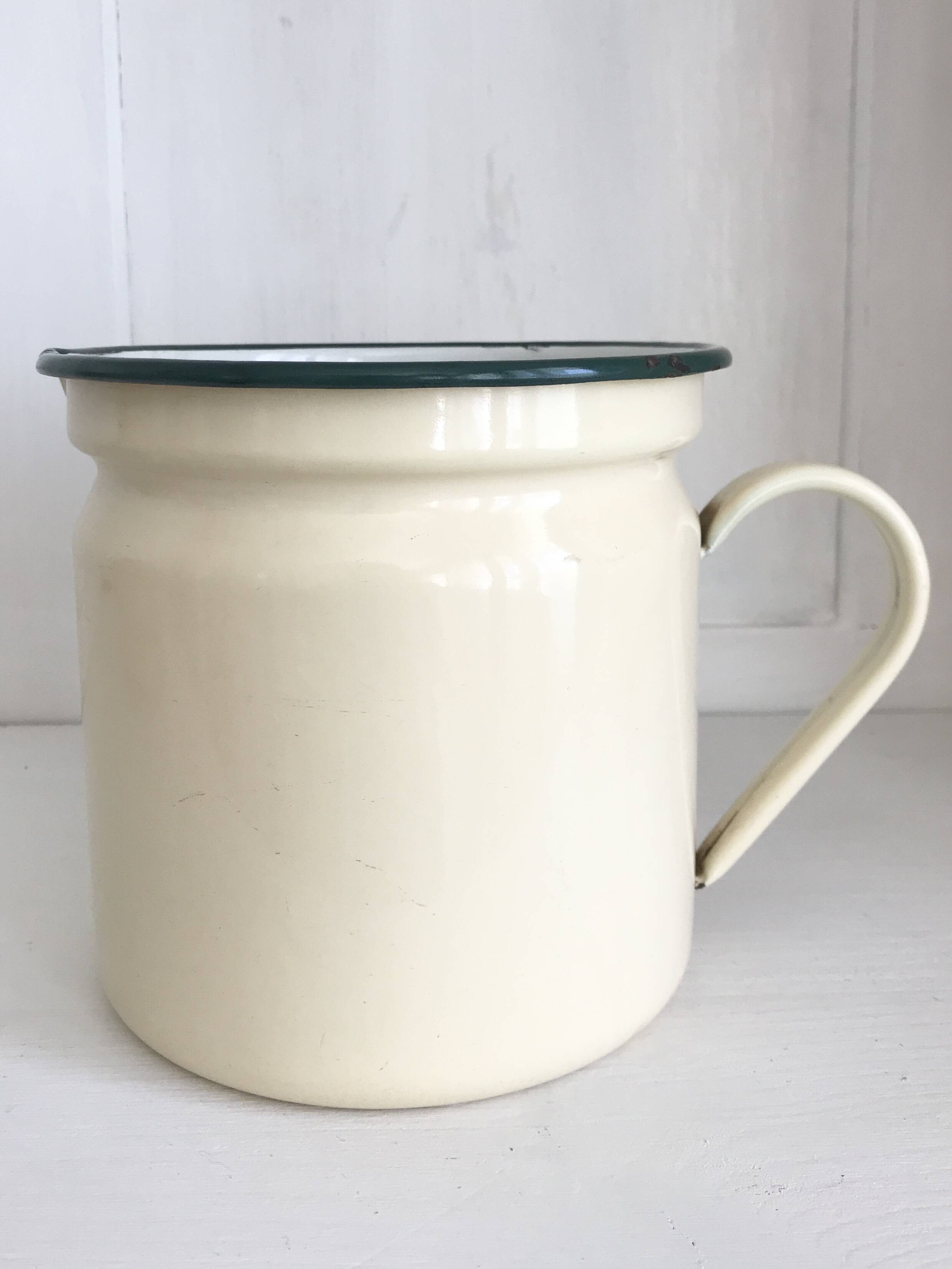 Old milk jug in enameled sheet metal