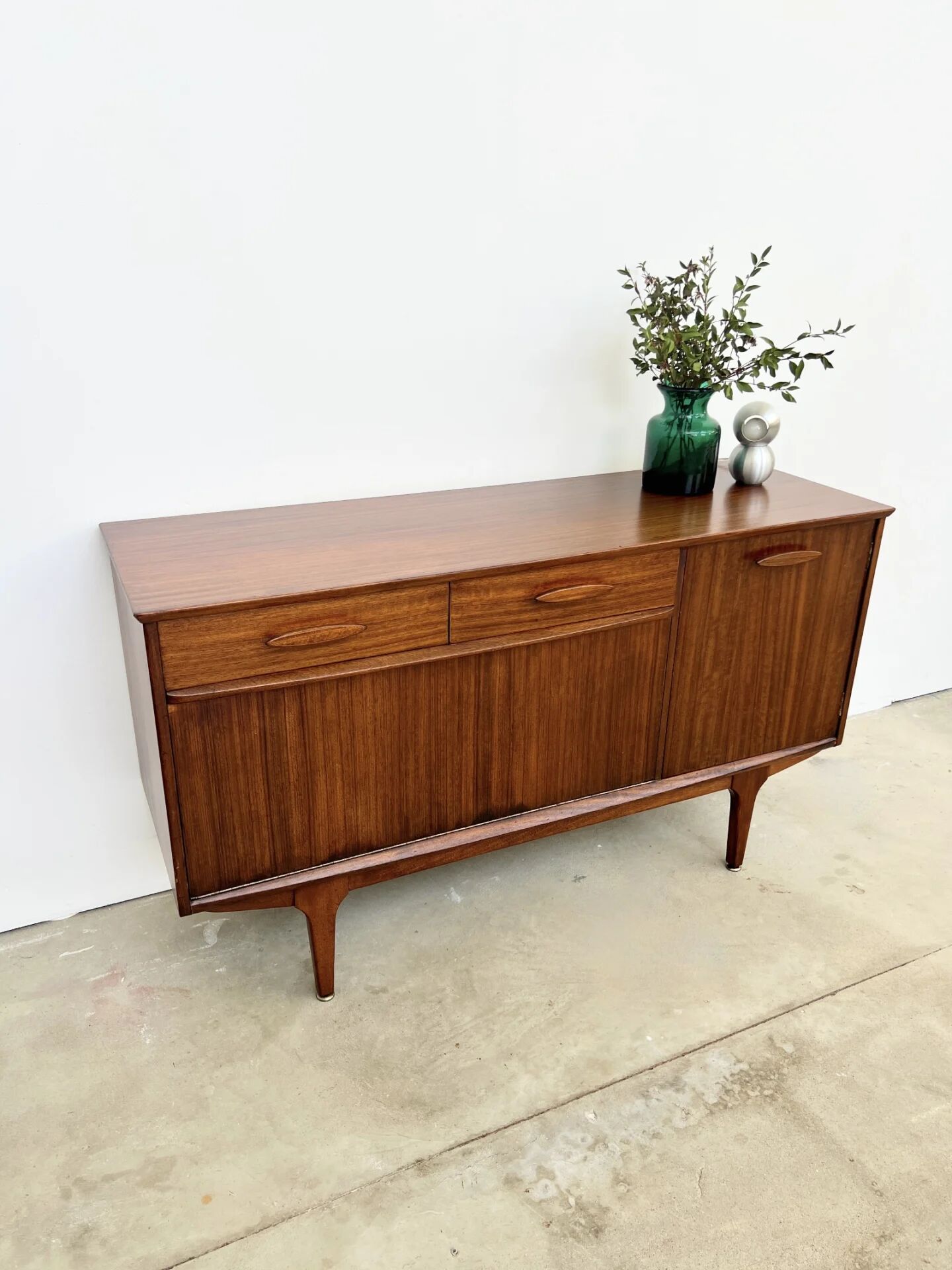Teak Jentique sideboard — 1 door, 2 drawers & drop-down bar, England 1950s-60s