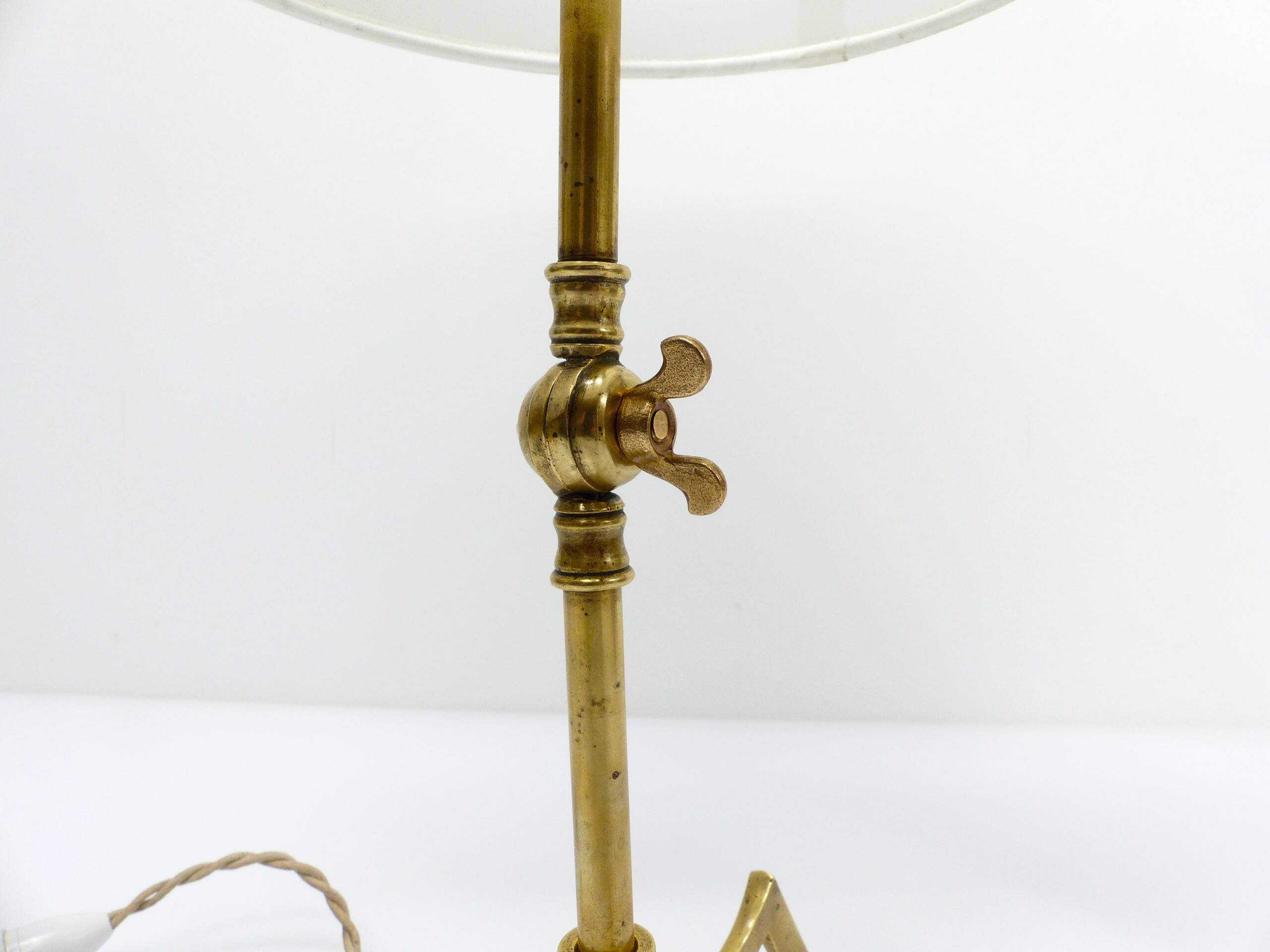 Articulated tripod lamp base in brass, Arts & Crafts style, in the manner of.