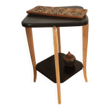 Black lacquered wooden side table with offset tops.