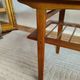 Scandinavian coffee table in teak with a lower shelf and brass bars.