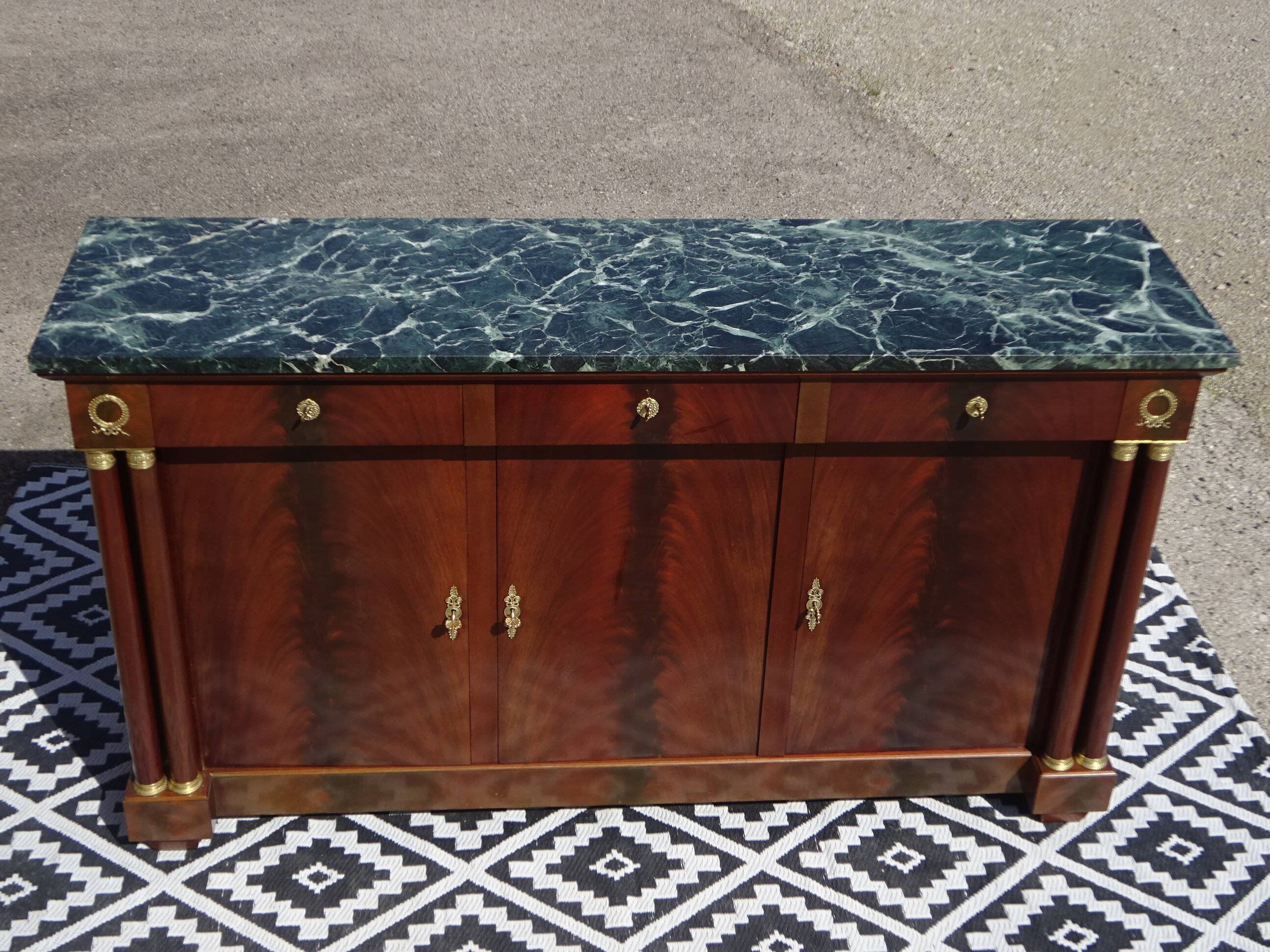 Flamed mahogany enfilade with sea green marble in Empire style.