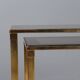 Nested tables in brass and smoked glass.