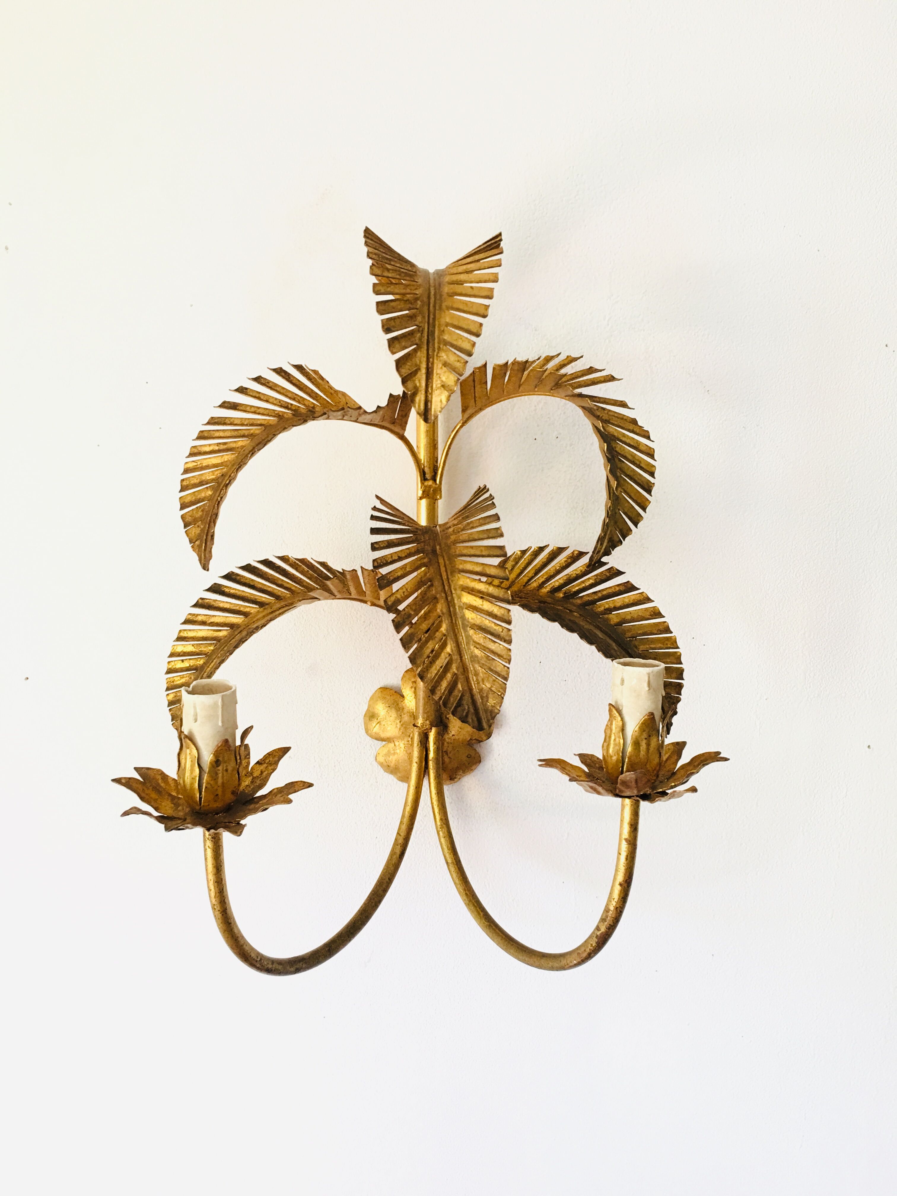 Golden palm leaf sconce