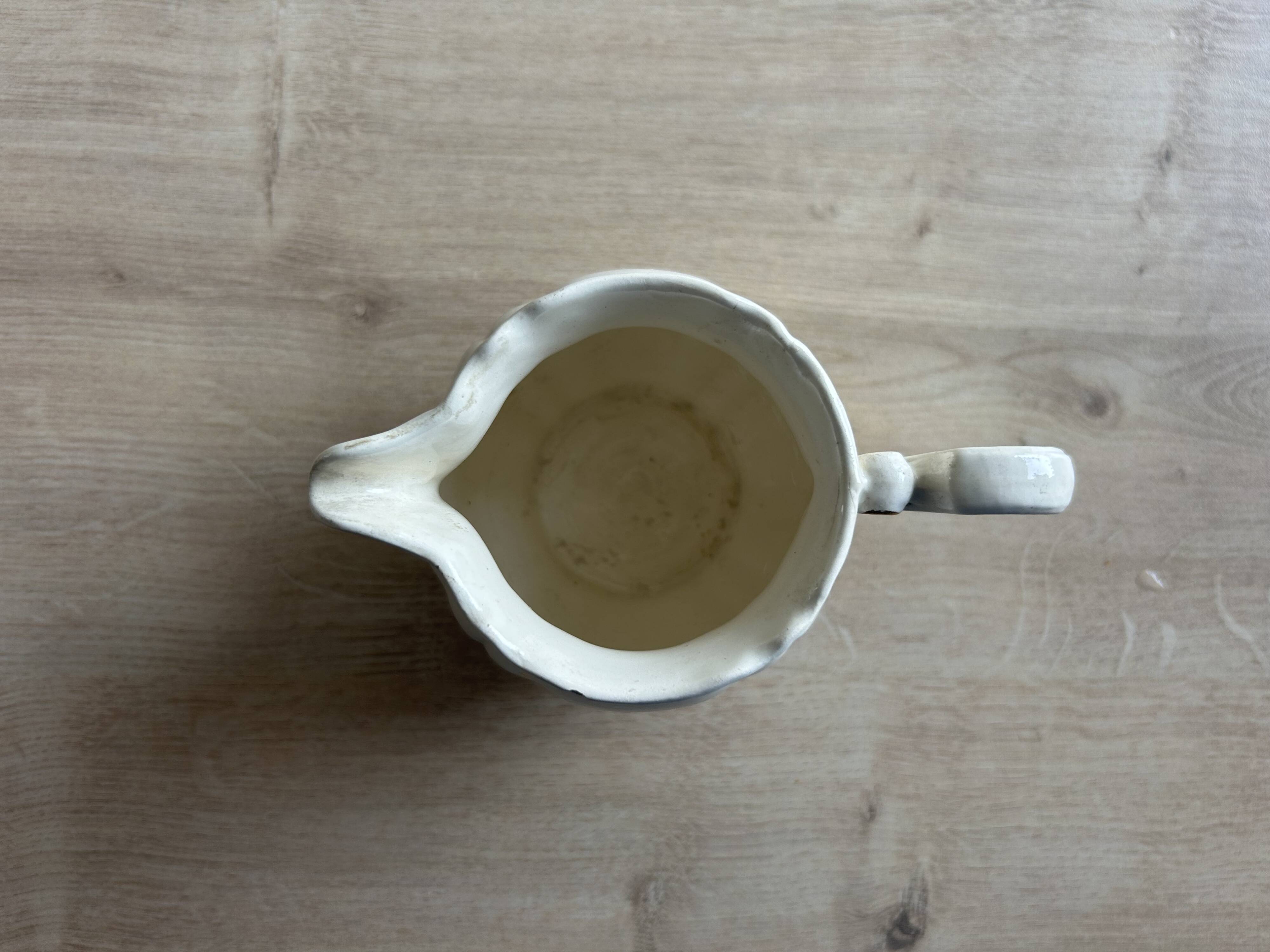 Old cream jug "Nous deux" in Sarreguemines earthenware.