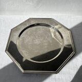 Many octagonal presentation plates in silver-plated metal.