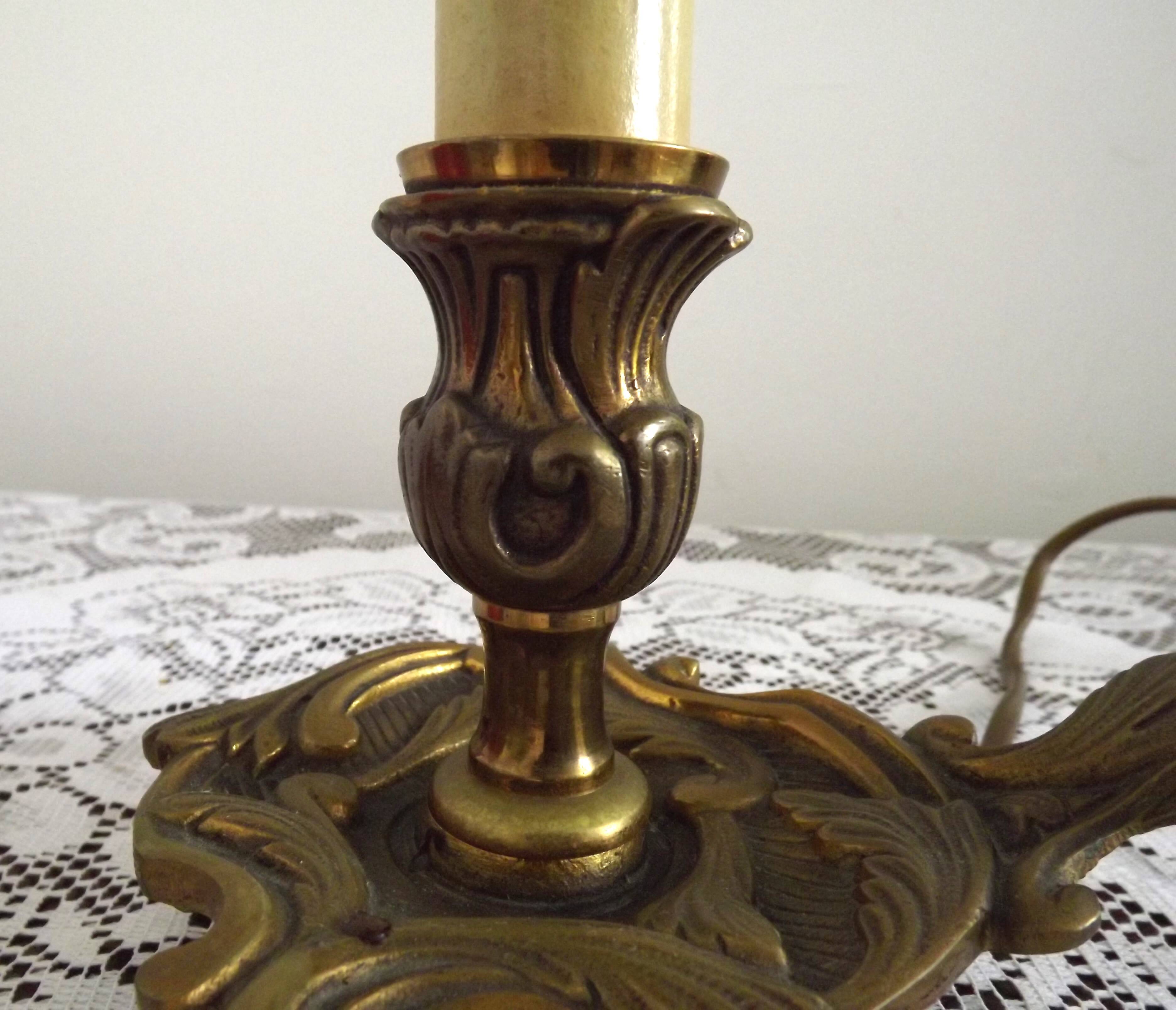 Vintage French bronze Wee Willie Winkie style lamp with red card shade.