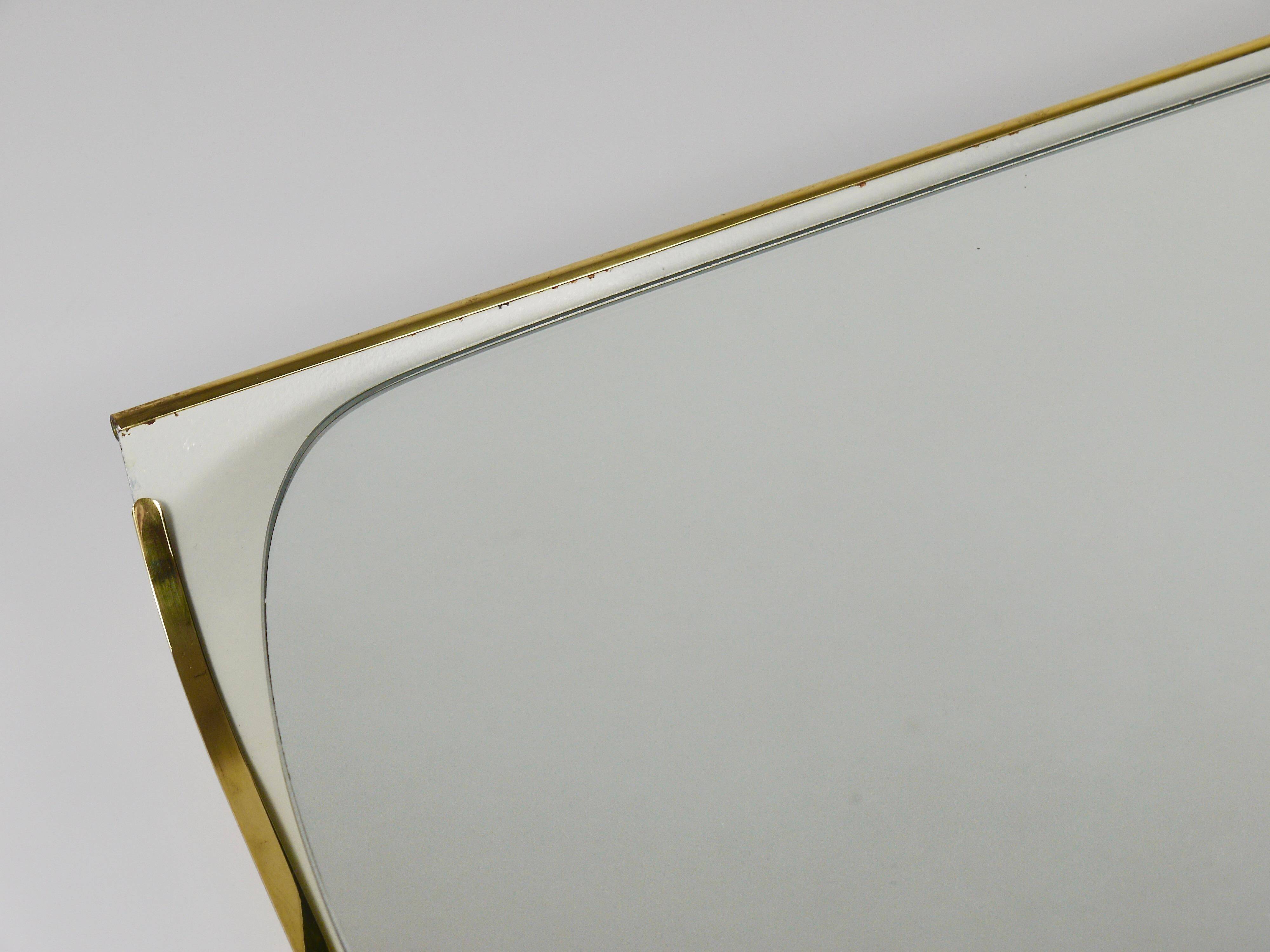 Mid-century illuminated wall mirror by Ernest Igl with brass crown, by Hillebrand.