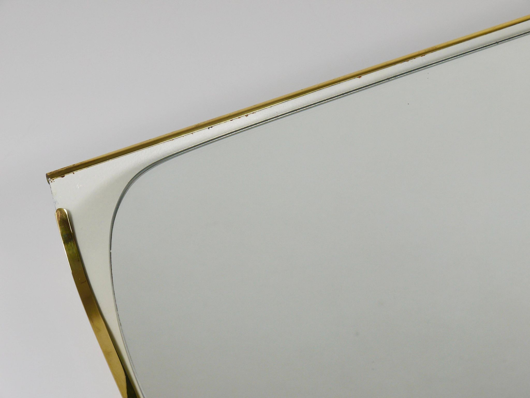 Mid-century illuminated wall mirror by Ernest Igl with brass crown, by Hillebrand.