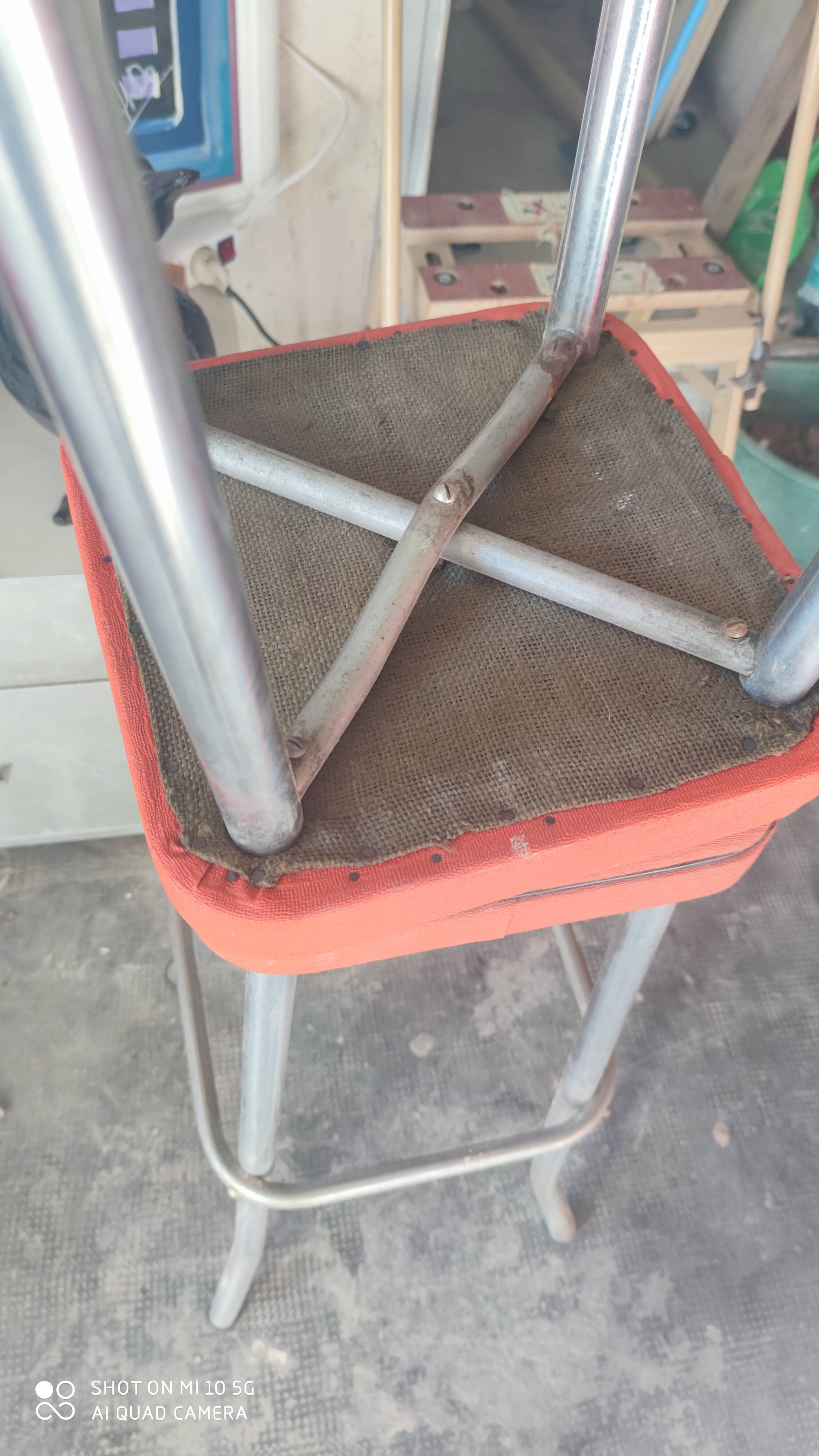 Pair of aluminum bar stools with orange and black seats