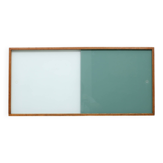 A vintage mid century wall hung bookcase/cabinet with glass sliding doors