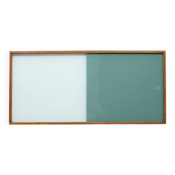 A vintage mid century wall hung bookcase/cabinet with glass sliding doors