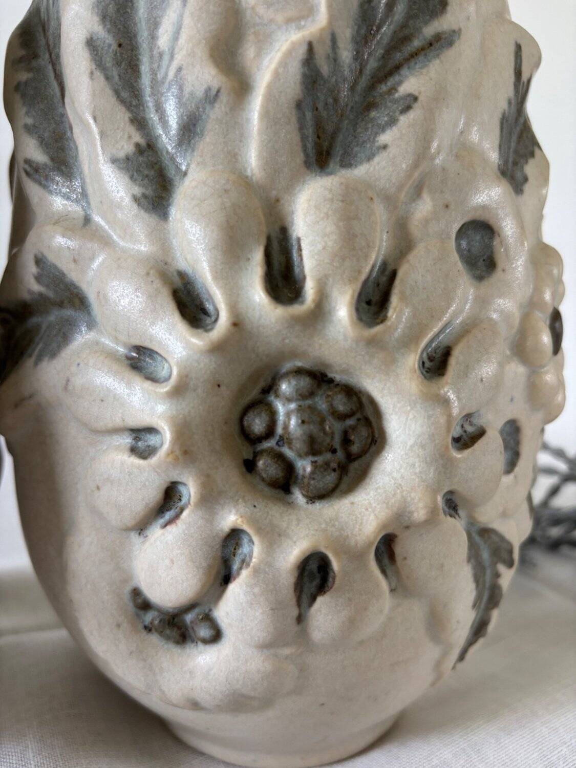 Pair of white glazed stoneware lamp bases, 20th-century floral decoration.