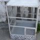 Vintage bird cage, made of wood and chicken wire metal square mesh