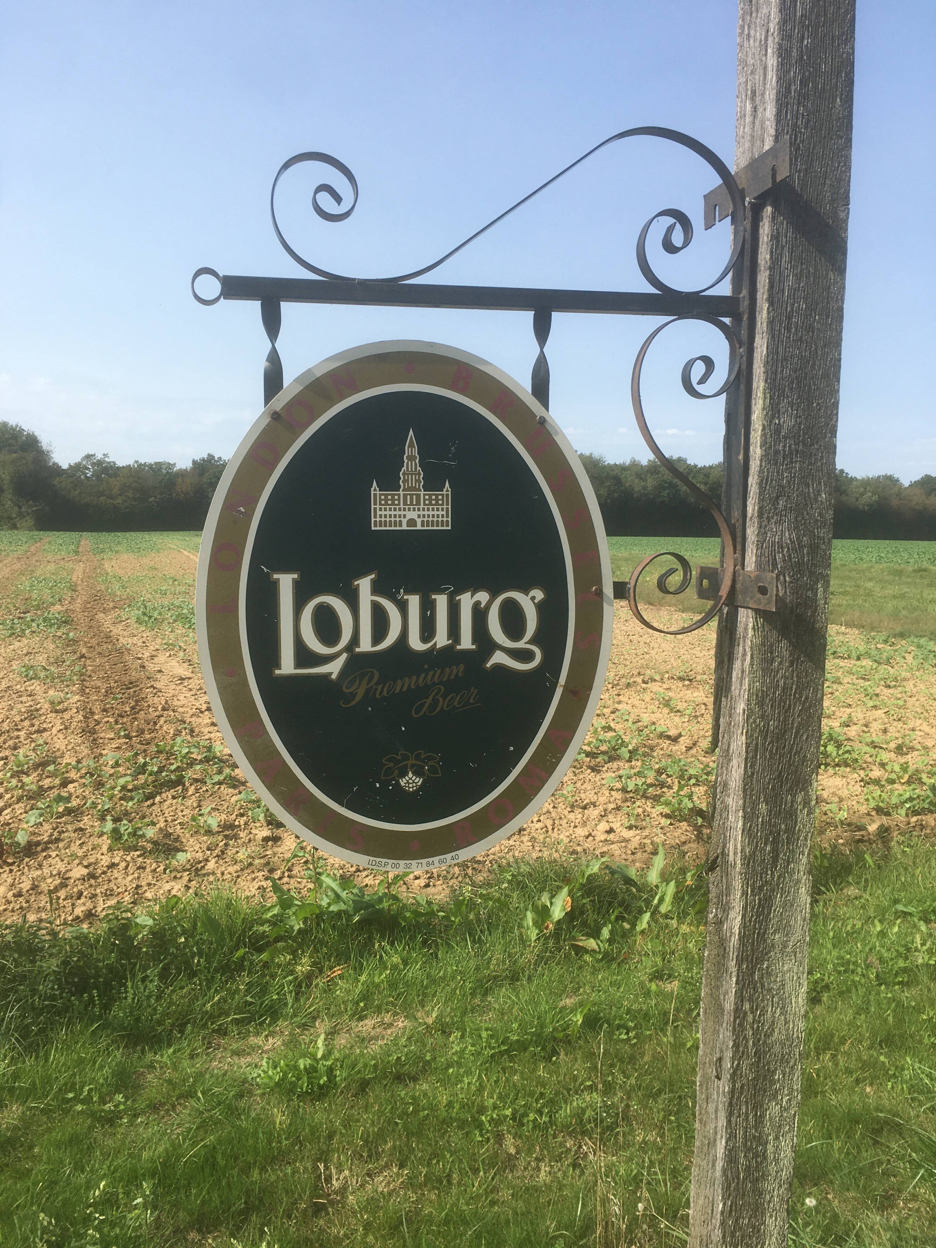 Double-sided "Loburg Beer" metal sign on wrought iron bracket