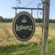 Double-sided "Loburg Beer" metal sign on wrought iron bracket