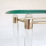 Hollywood Regency console table in lucite, glass and gold metal. 1980s