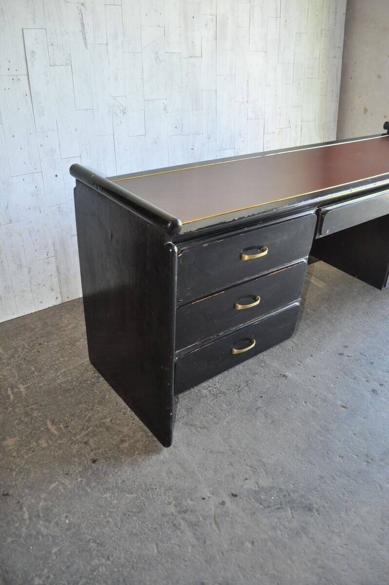 Hungarian Art Deco desk in black painted wood with a brown top and metal handles.