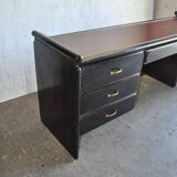 Hungarian Art Deco desk in black painted wood with a brown top and metal handles.