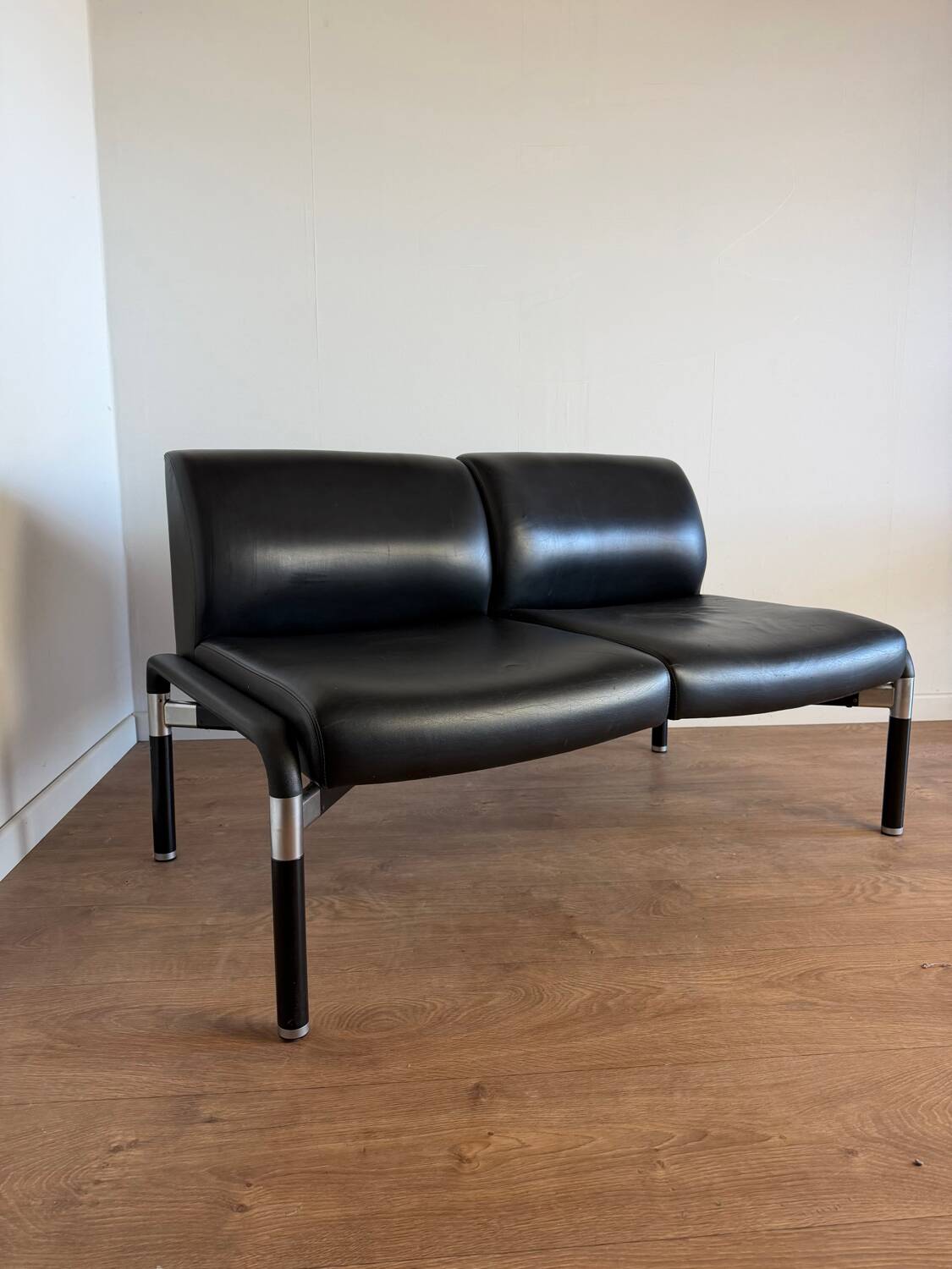 Vintage 2-seater banquette in black faux leather – 1980s