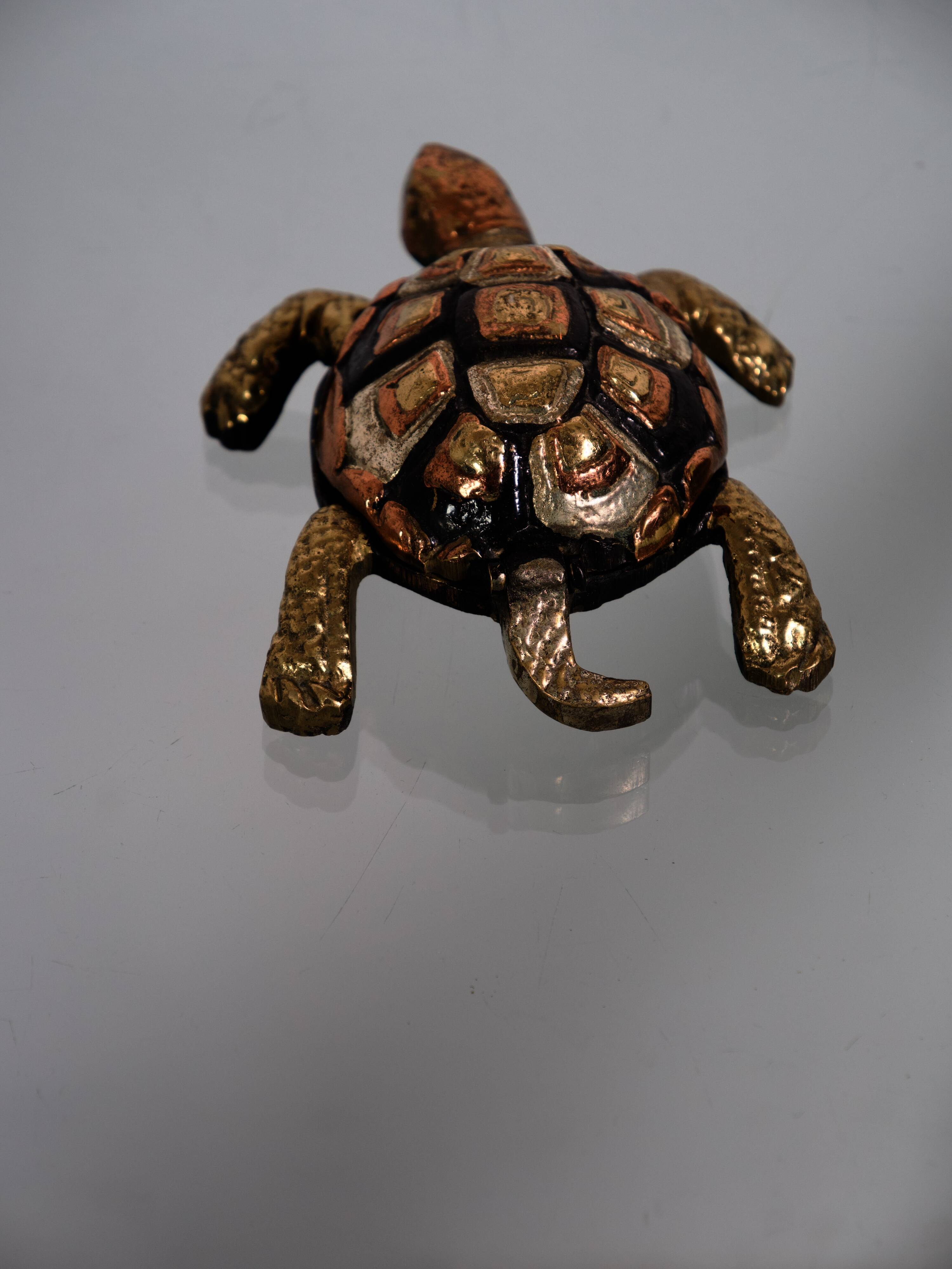 Golden brass turtle in decorative ashtray
