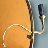 Oval wall mirror in gilded brass with double sconces – 1950s/60s