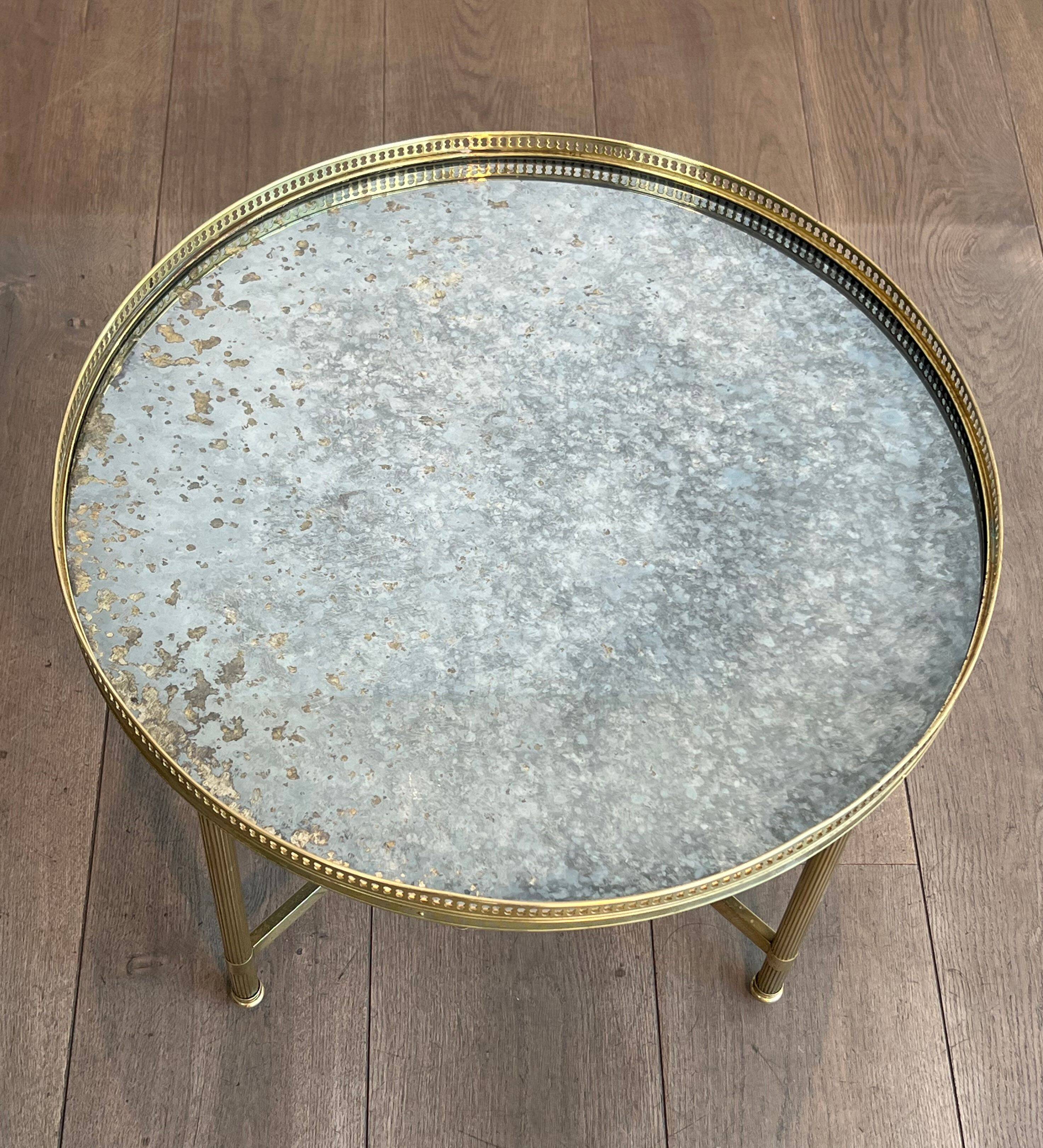 Brass coffee table with a vintage mirror top from the Baguès house.