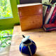 Small blue ceramic pot with metal frame and lid.
