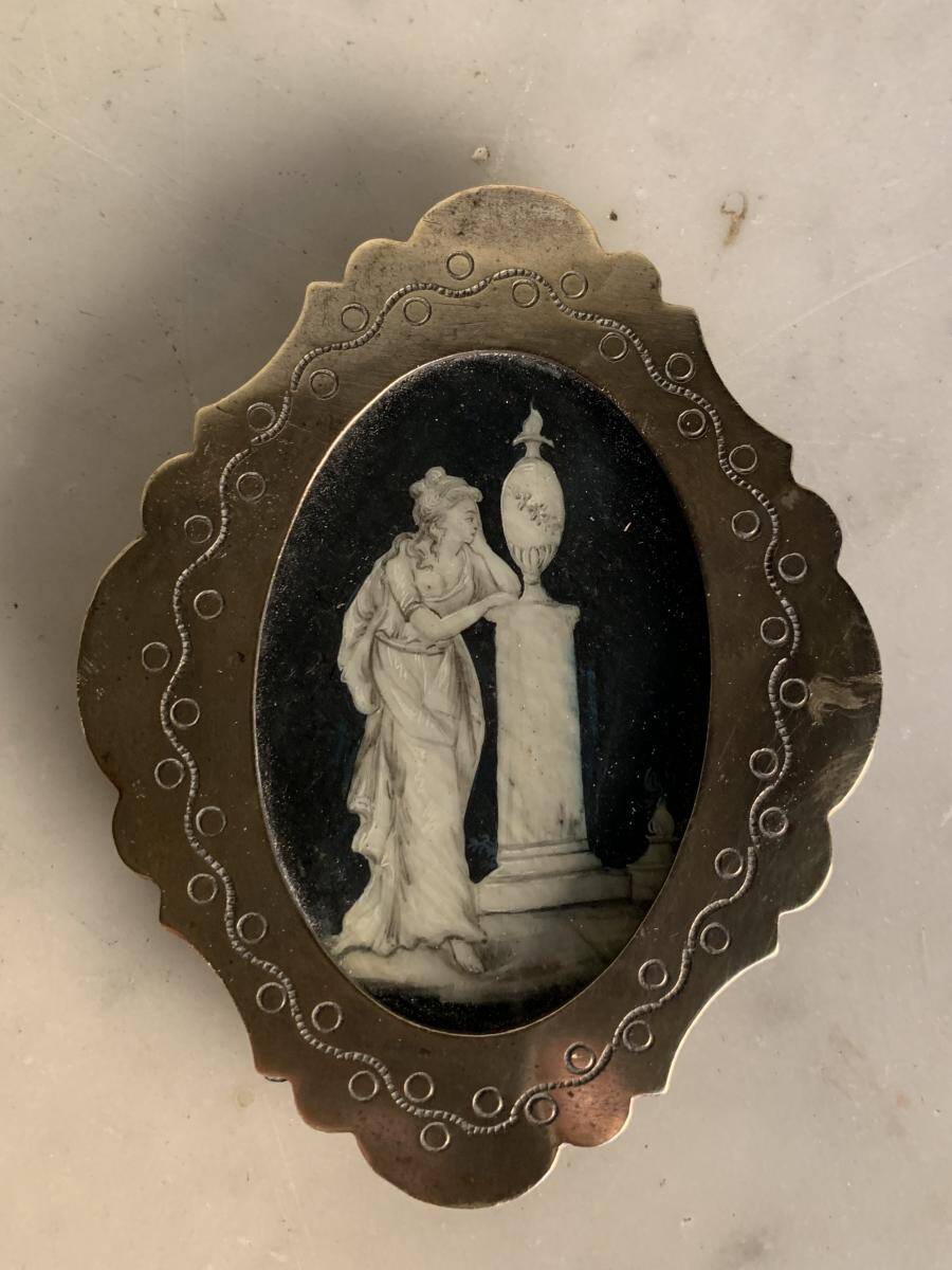Miniature on ivory, oval brass frame.
