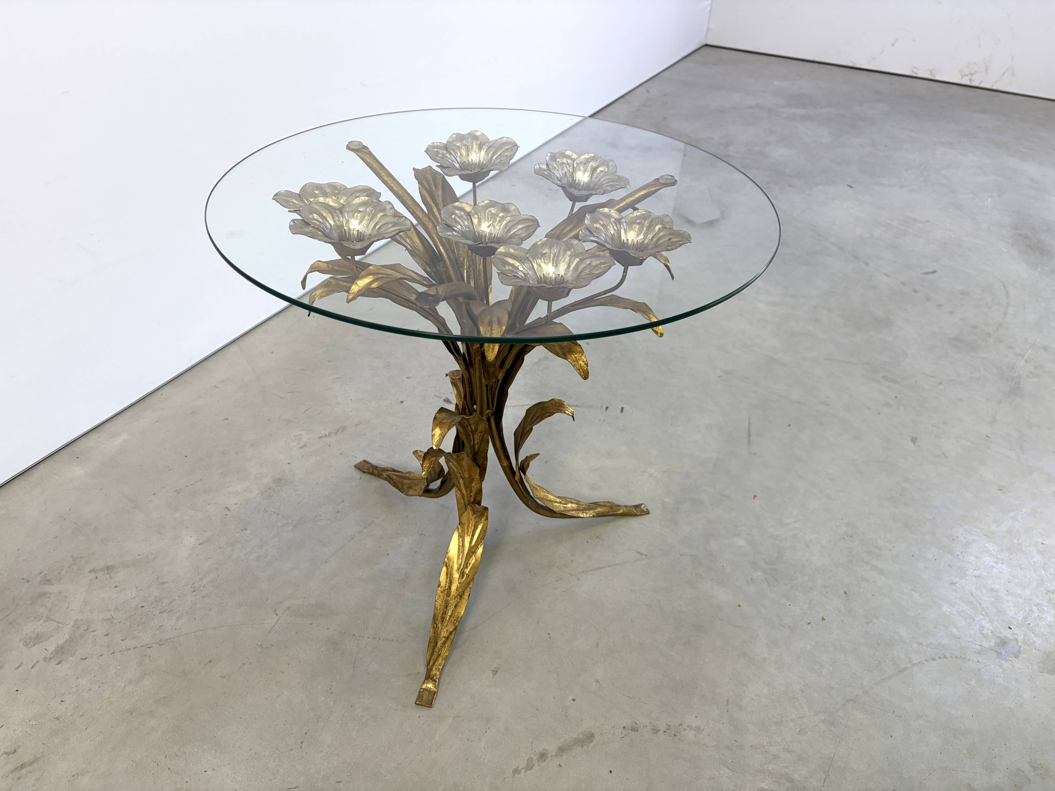 Charming metal flower coffee table or side table with a clear glass top. Made in Italy, attributed to Hans Kögl.