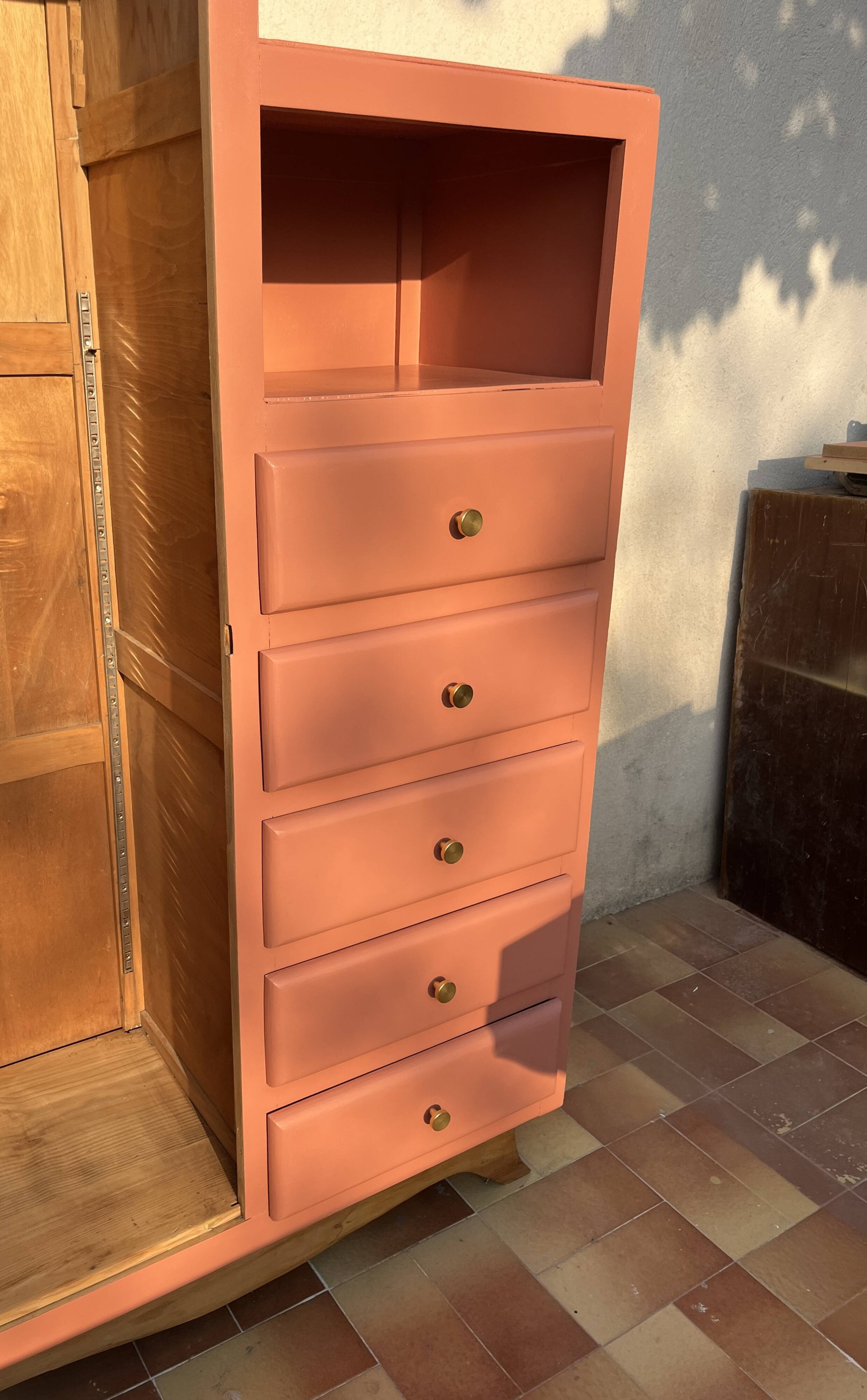 Asymmetrical vintage wardrobe painted in terracotta.