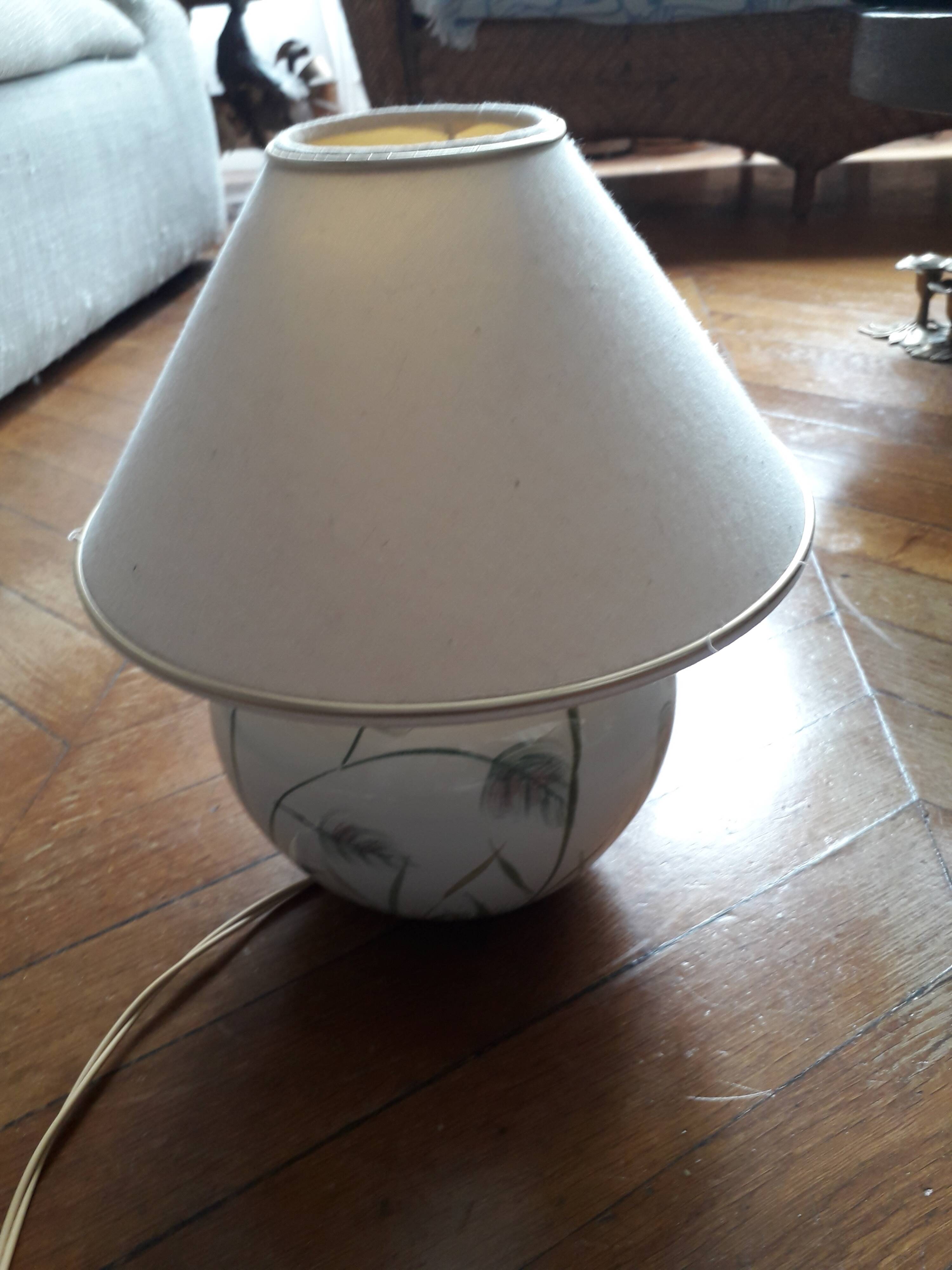 Antique ceramic lamp with a floral design.