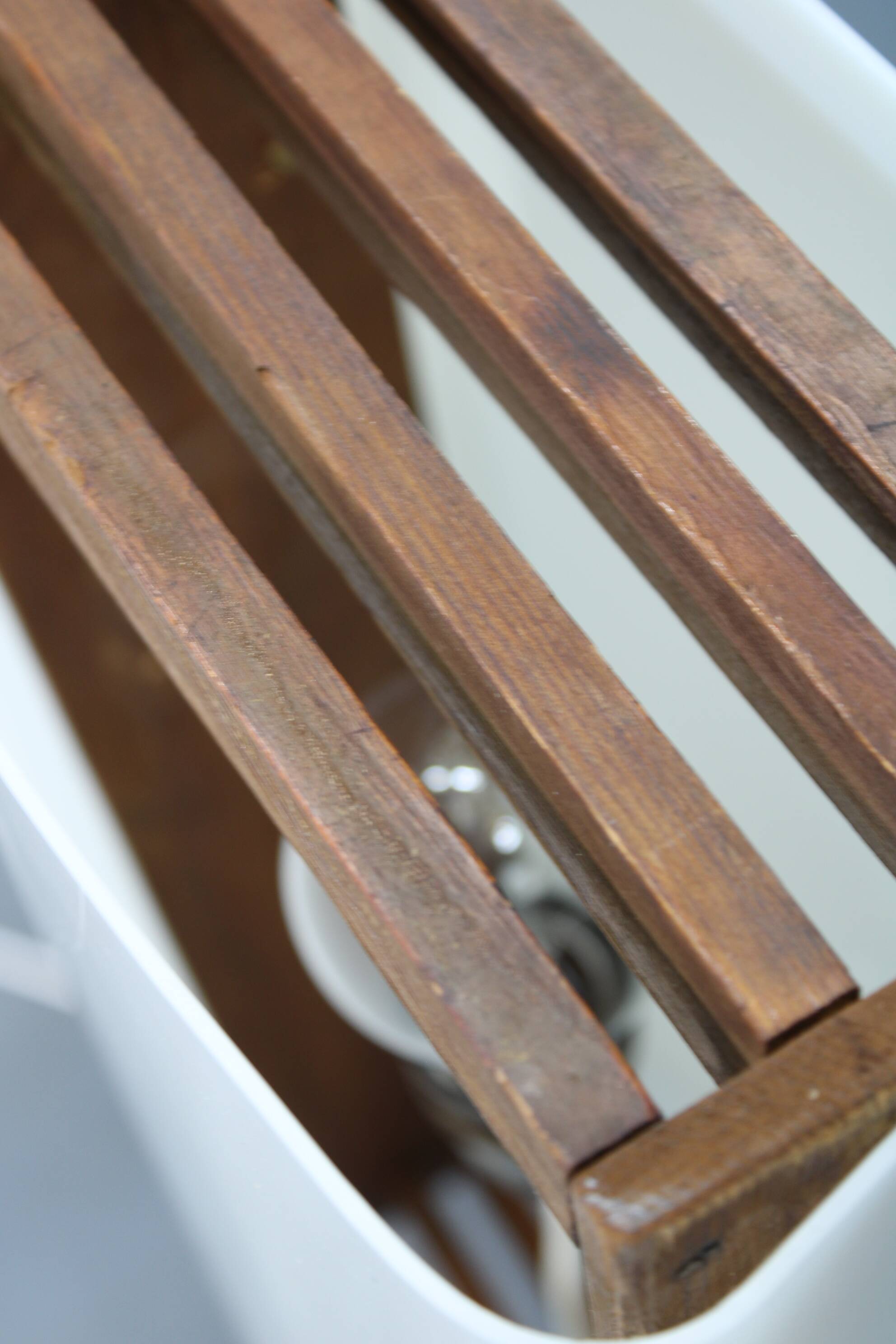 Mid-century modern floor lamp on iron legs with plastic shade and wood accent