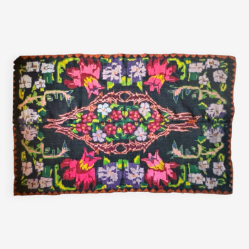 Bohemian floral design, handwoven wool rug, black background with colorful flowers