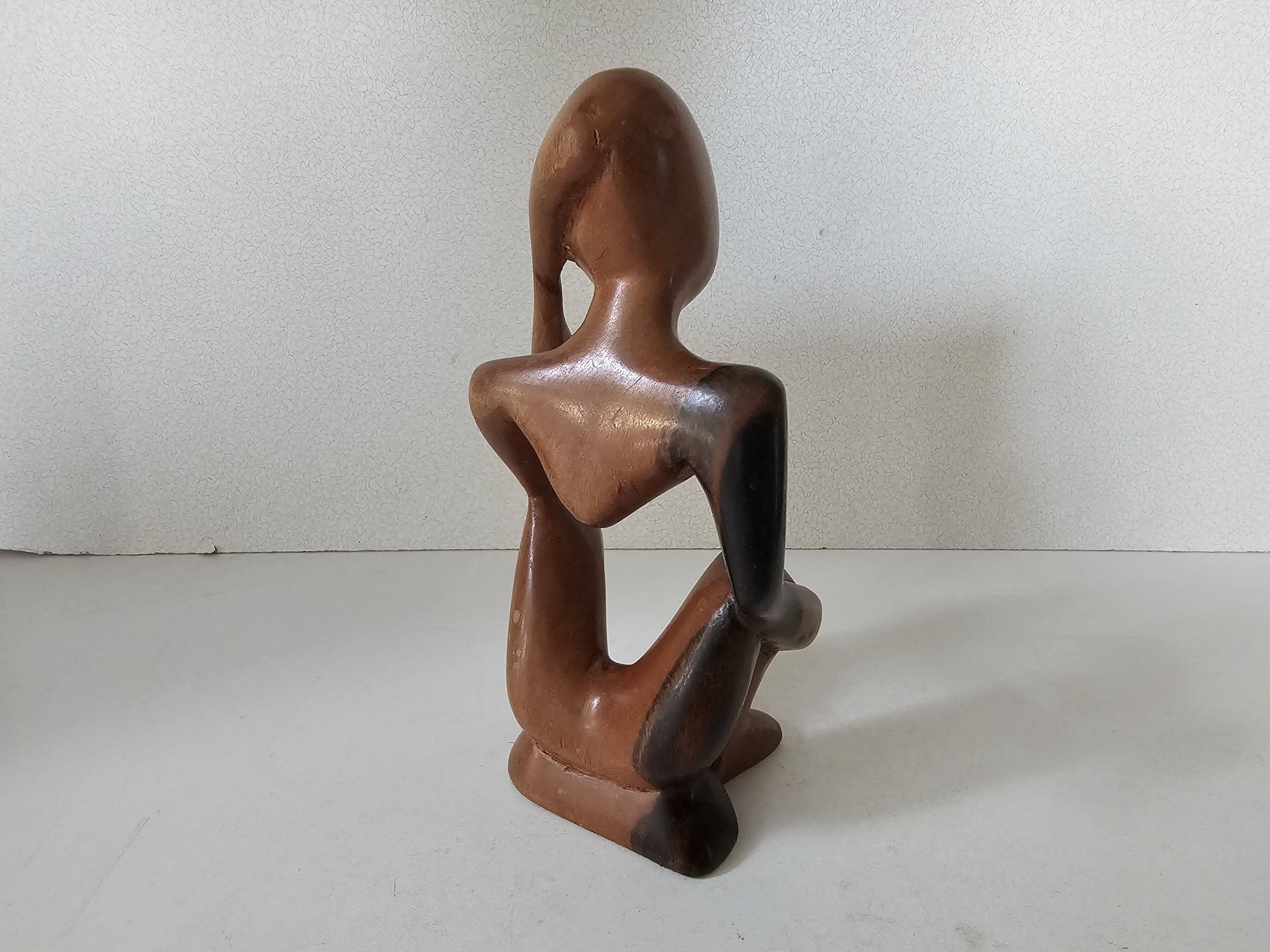 Wooden statuette sculpture of a thinking man design