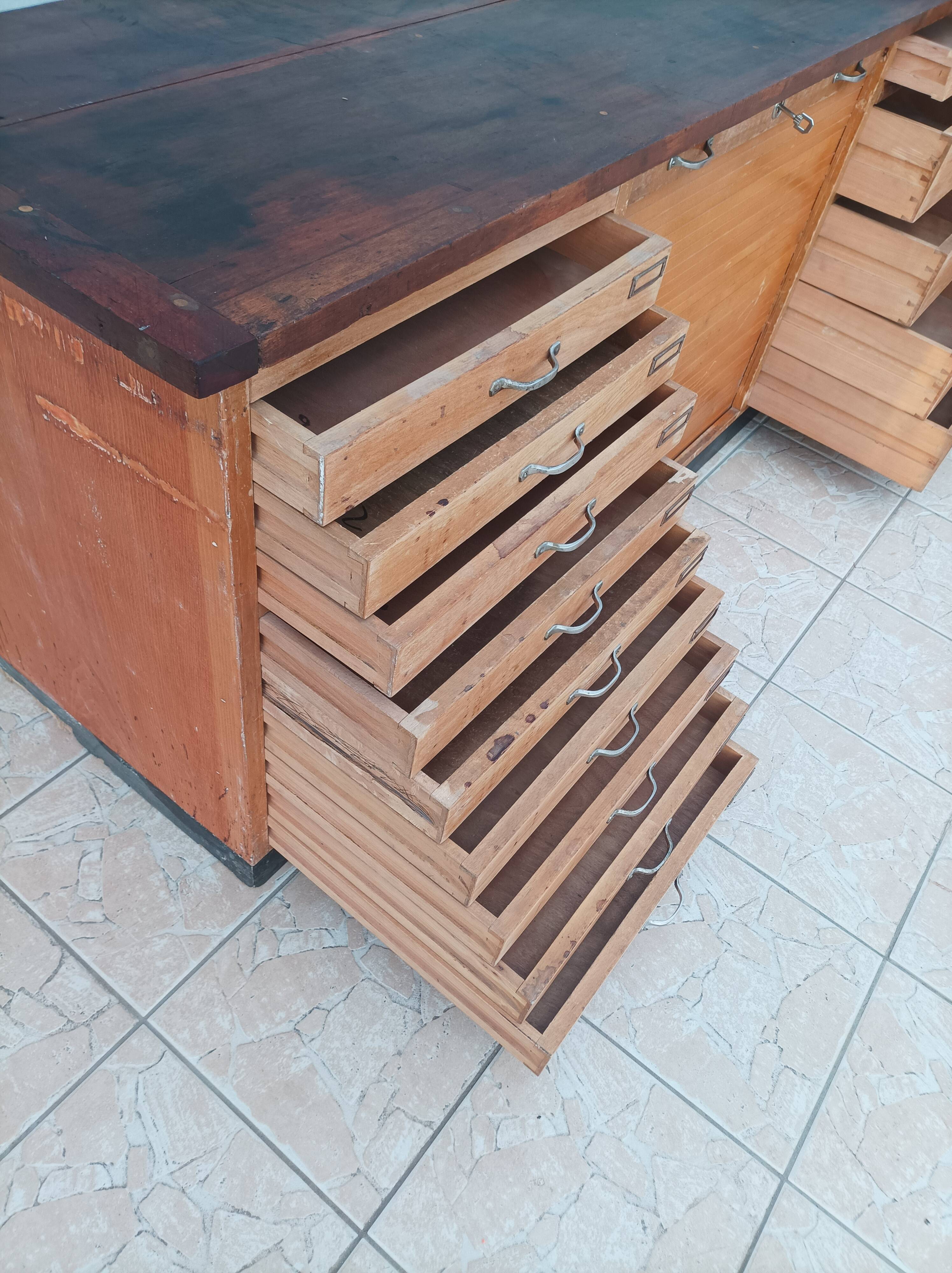 Workshop furniture with drawers and curtain in beech and walnut.