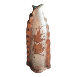 Small clay vase decorated with leaves