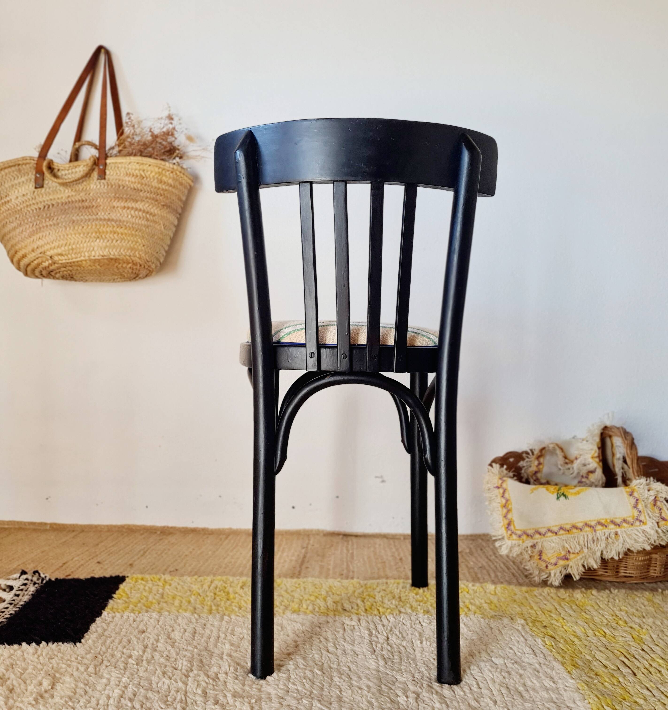 Curved black wooden bistro chair with striped seat