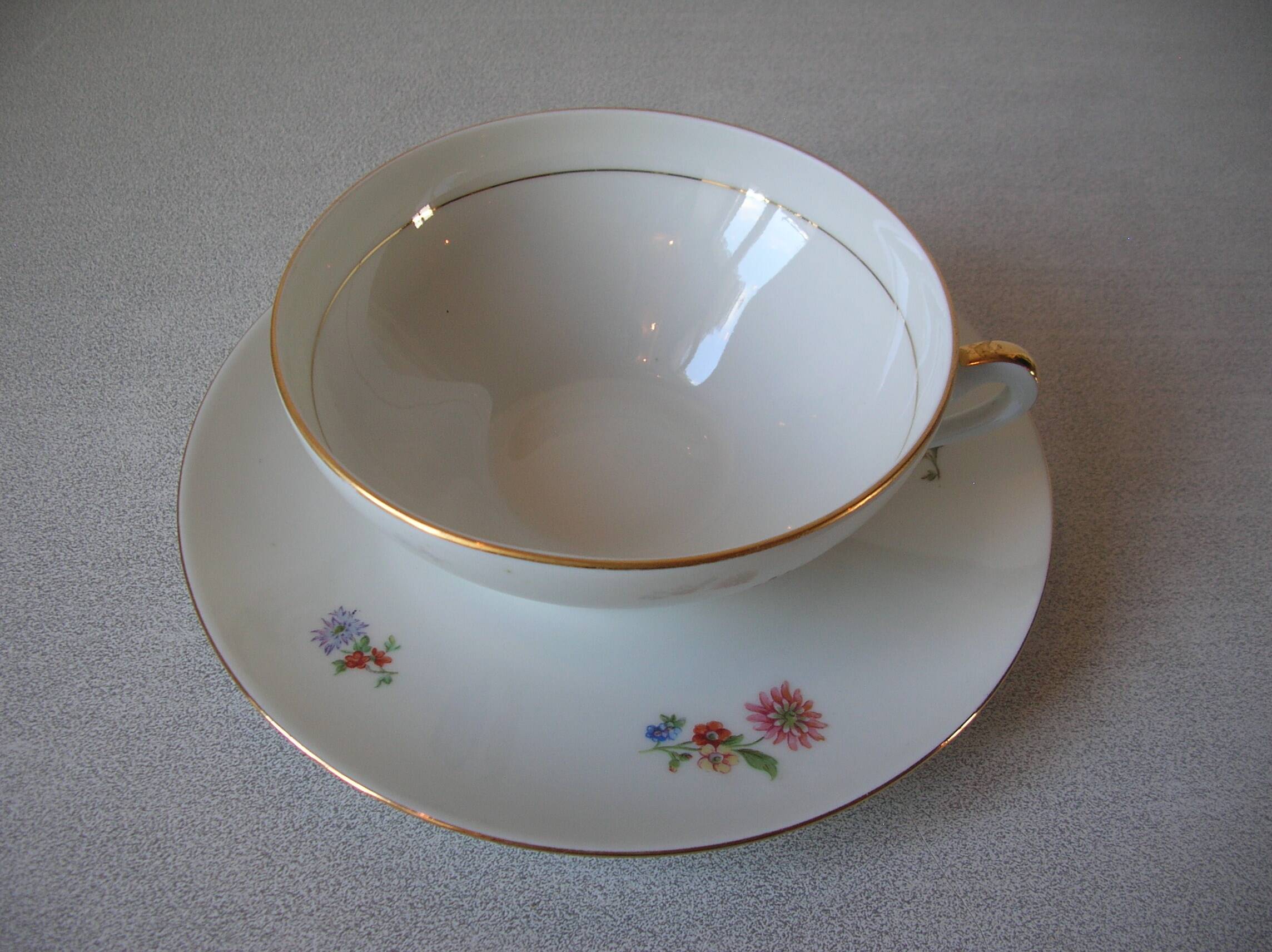 Old large tea cup and saucer in Limoges porcelain with flower decor