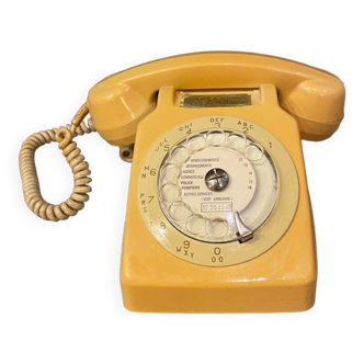 Old dial telephone from the 80s temat quimper bakelite yellow and beige
