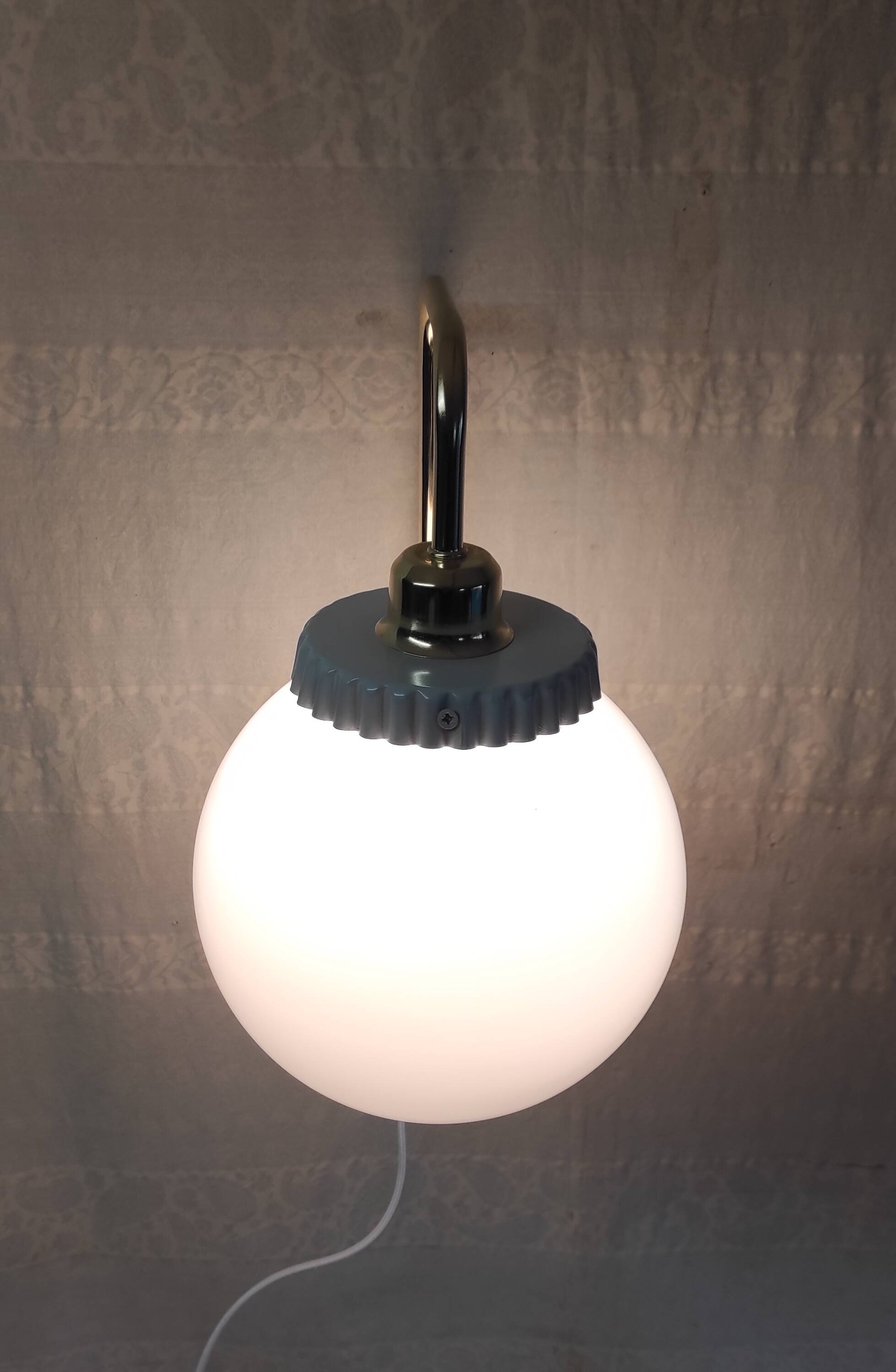 Opaline glass globe wall sconce with a gilt metal bracket - mid-20th century