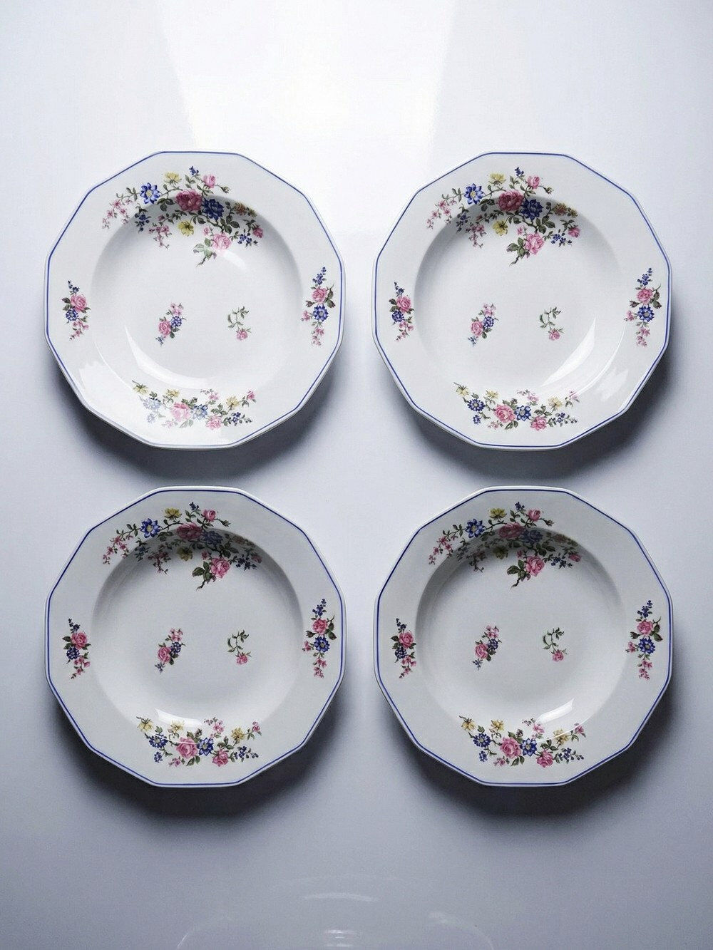 4 flat plates by Bernardaud, Limoges porcelain, floral decoration from the 1920s to 1950s.