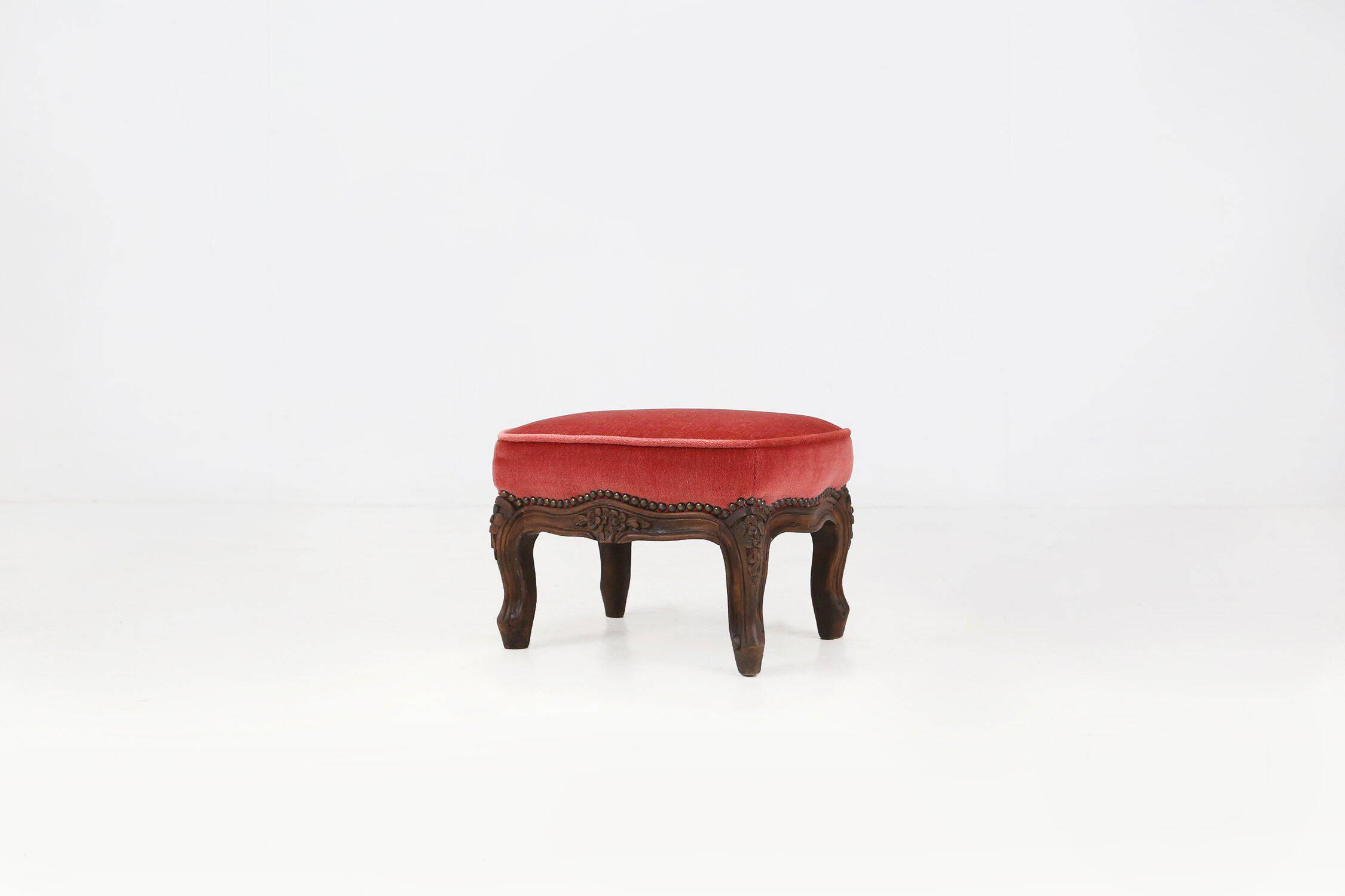 Baroque style foot stool in carved wood with coral velvet upholstery