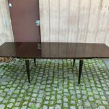 Scandinavian extendable dining table made of solid wood and rosewood effect.