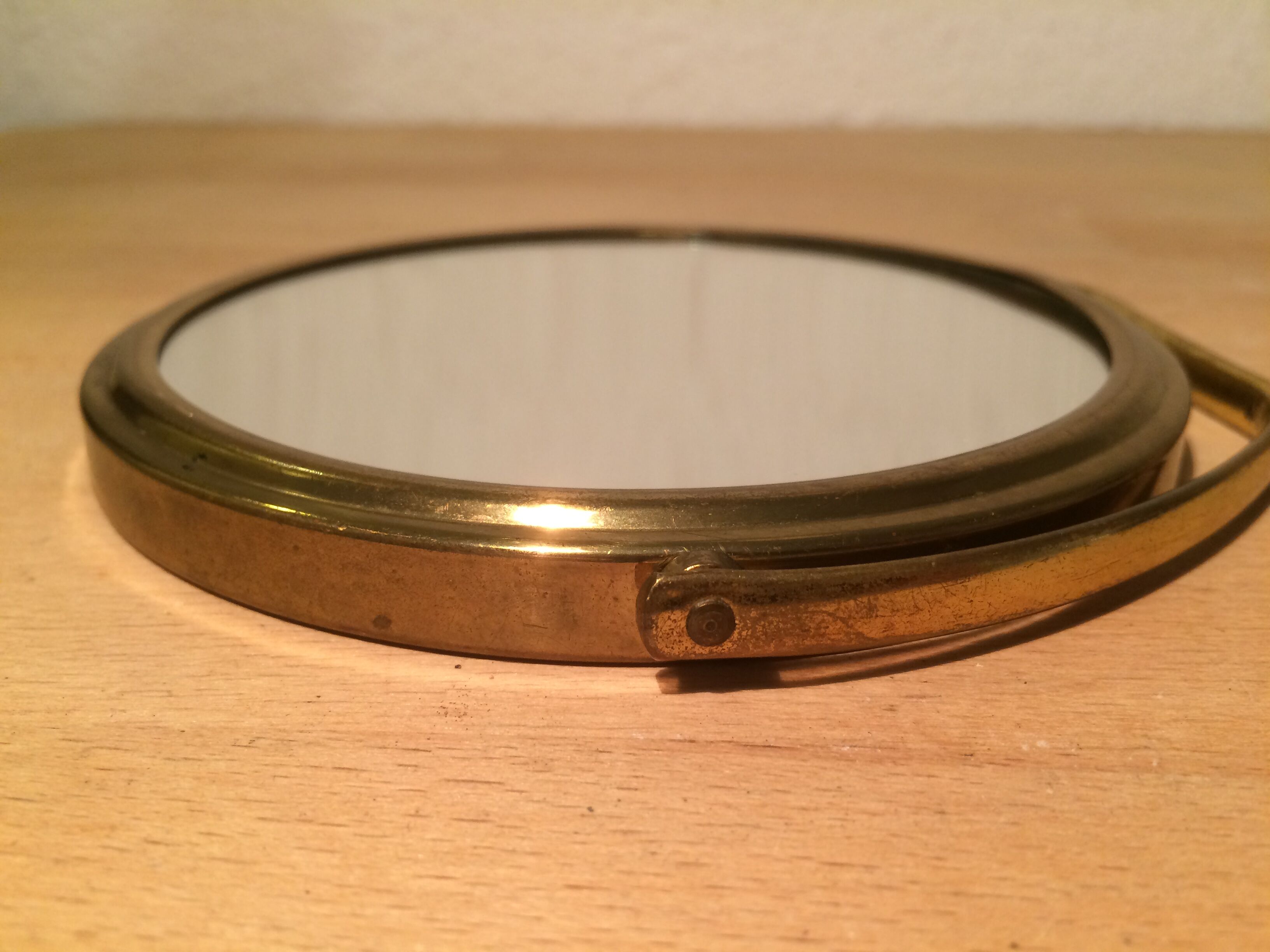 Vintage magnifiing gold round barber mirror