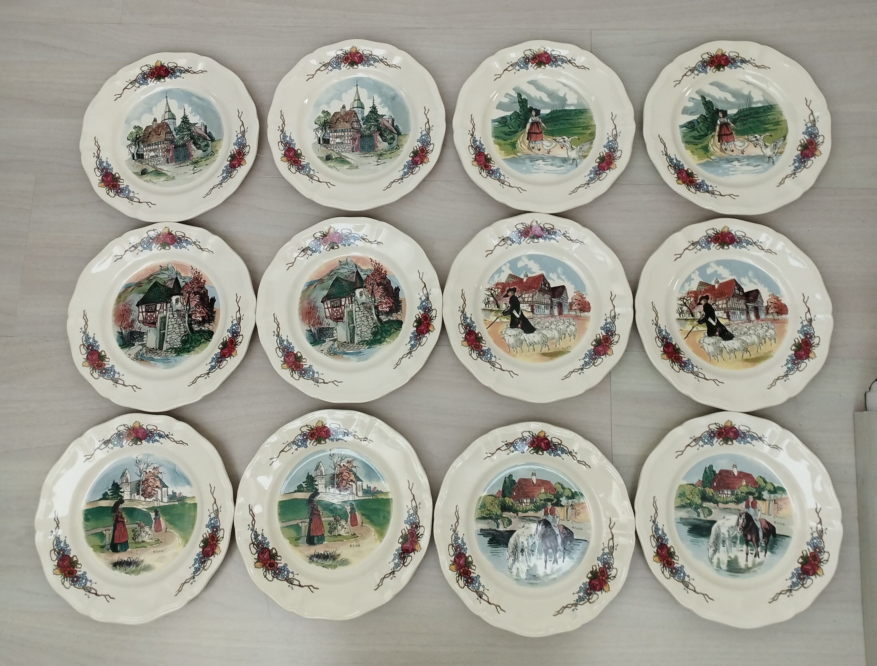 12 plates of the Obernai earthenware décor service signed Henri Loux
