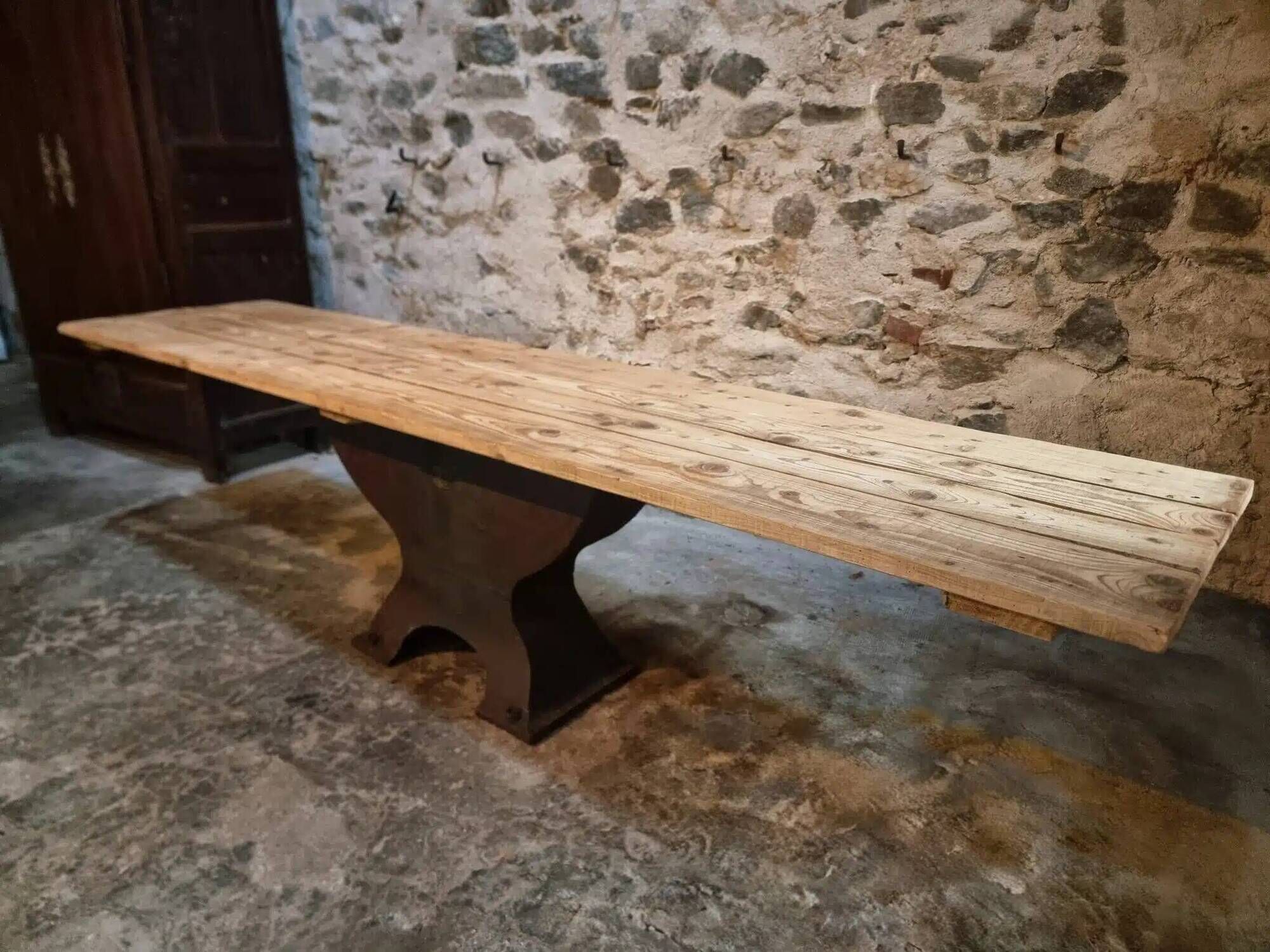 Old French industrial table with a cast iron base and a pine top.