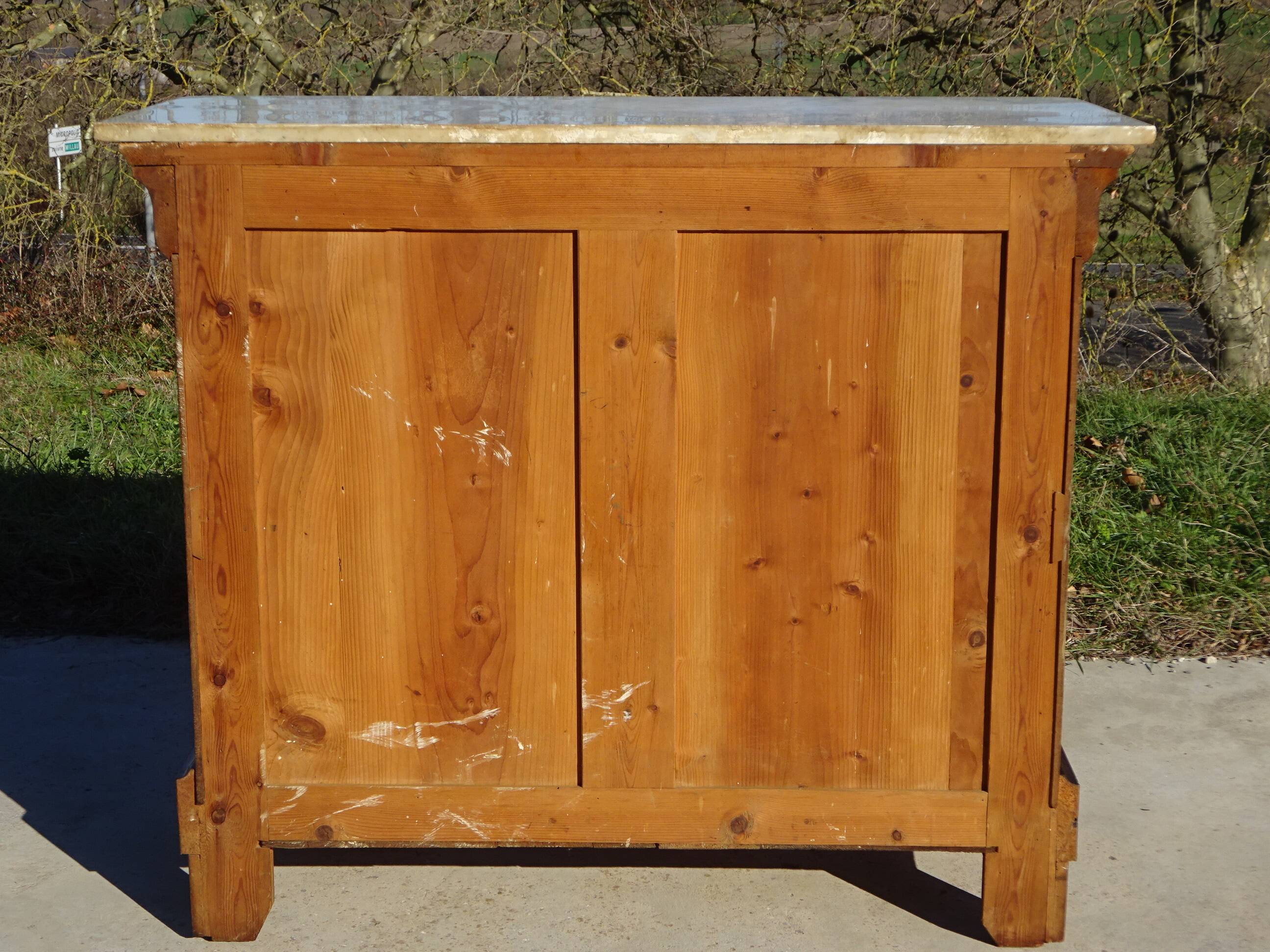 Antique mahogany chest of drawers with white marble.