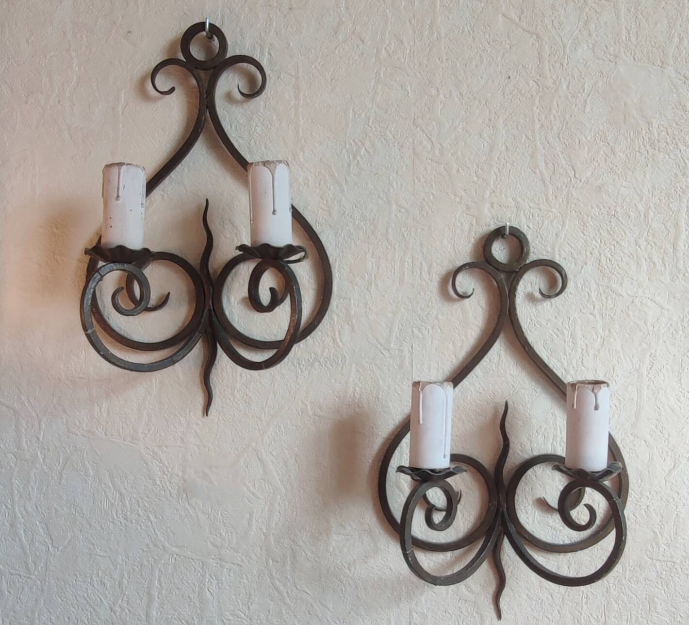 Old pair of wrought iron wall lights