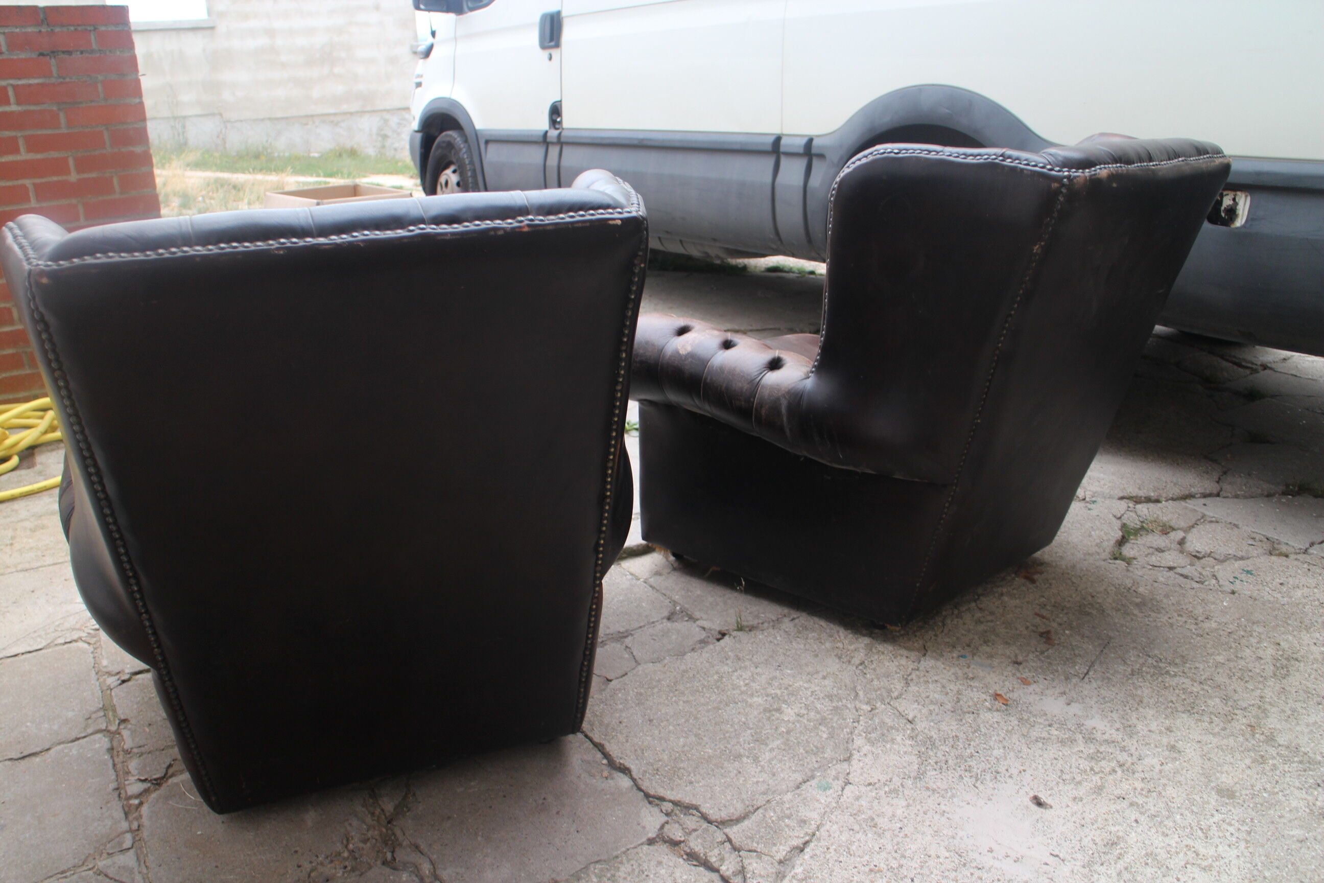 Padded chesterfield leather armchairs